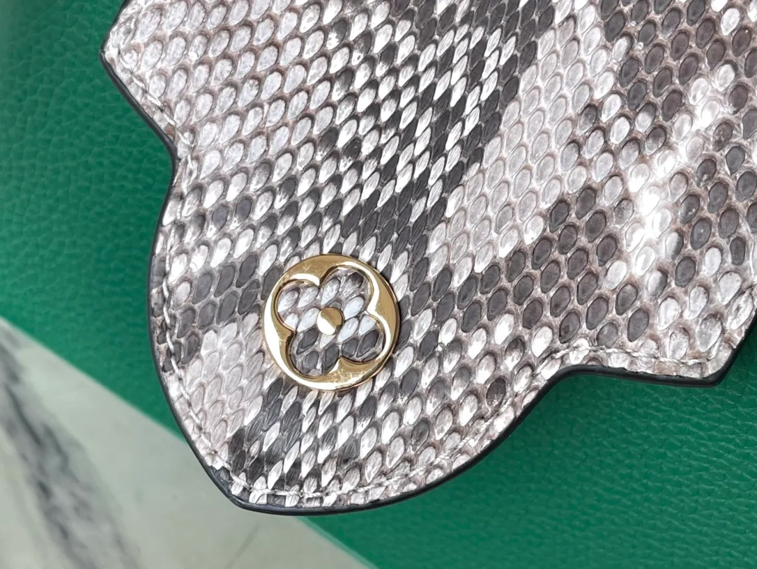 💰1860 (extra-grade original leather) N99387/M95509 green snake shoulder. This Capucines mini handbag is exquisitely constructed with full-grain Taurillon leather. It is equipped with a top handle, two flaps and a logo outlined in luster python leather, making it a gorgeous choice for both day and night. The detachable wide shoulder strap allows for an avant-garde look when worn on the shoulder or crossbody. Size: 21 *14 * 8cm
