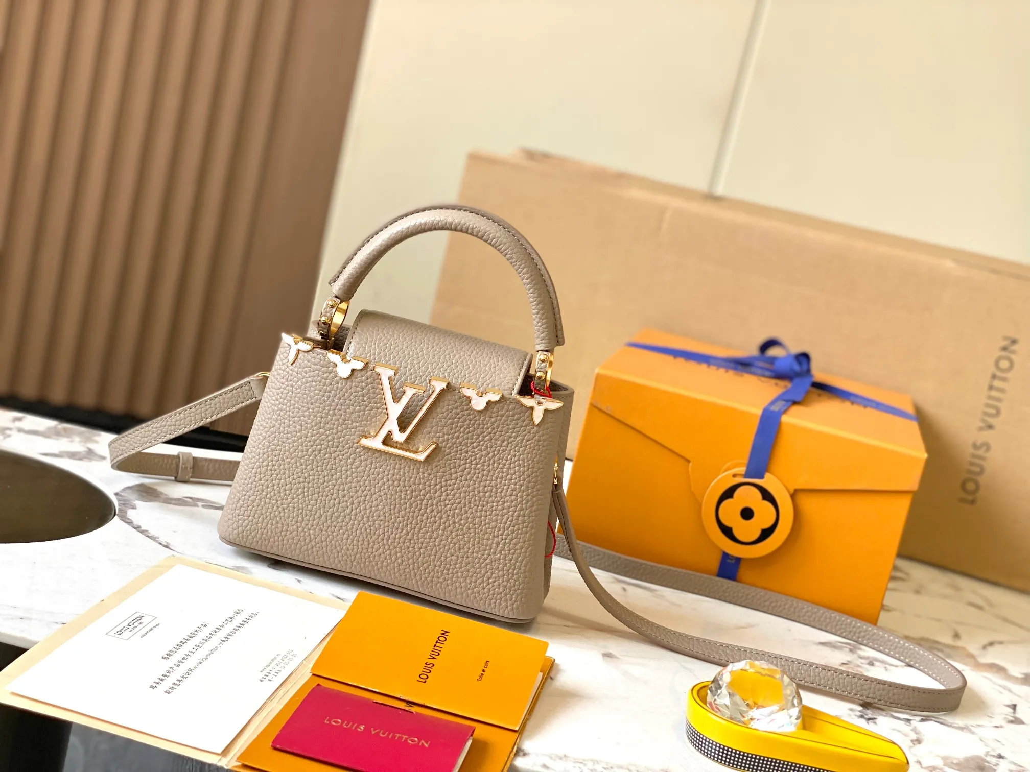 P2400 [Super high-quality original leather💋 M23330 elephant gray and white shell hardware] Capucines mini handbag, this Capucines Flower Crown handbag is made of full-grain Taurillon leather embellished with Monogram flowers. Each flower is shaped by exquisite shells. The LV logo and flowers echo each other, giving this soft handbag a jewel-like luster. Use the detachable shoulder strap cleverly to switch between shoulder and crossbody styles! Size: 21*14*8Cm