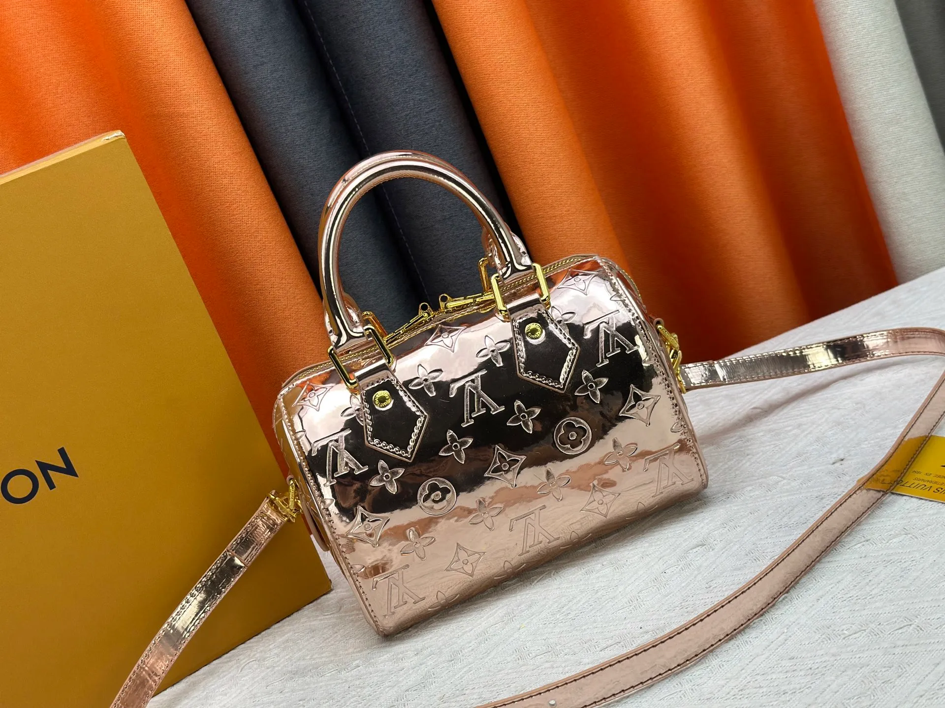 P260 M26497 M11987 M58953 Rose gold This Speedy Bandoulière 20 handbag is from the LV Ski series. It is made of embossed coated canvas with smooth leather trimming and bright metal parts, and then uses the new Monogram Miroir effect to declare the retro-futuristic concept. The detachable and adjustable leather shoulder strap allows for a variety of carrying options, and the compact design can accommodate daily needs such as a long wallet. Dimensions: 20.5x13.5x12