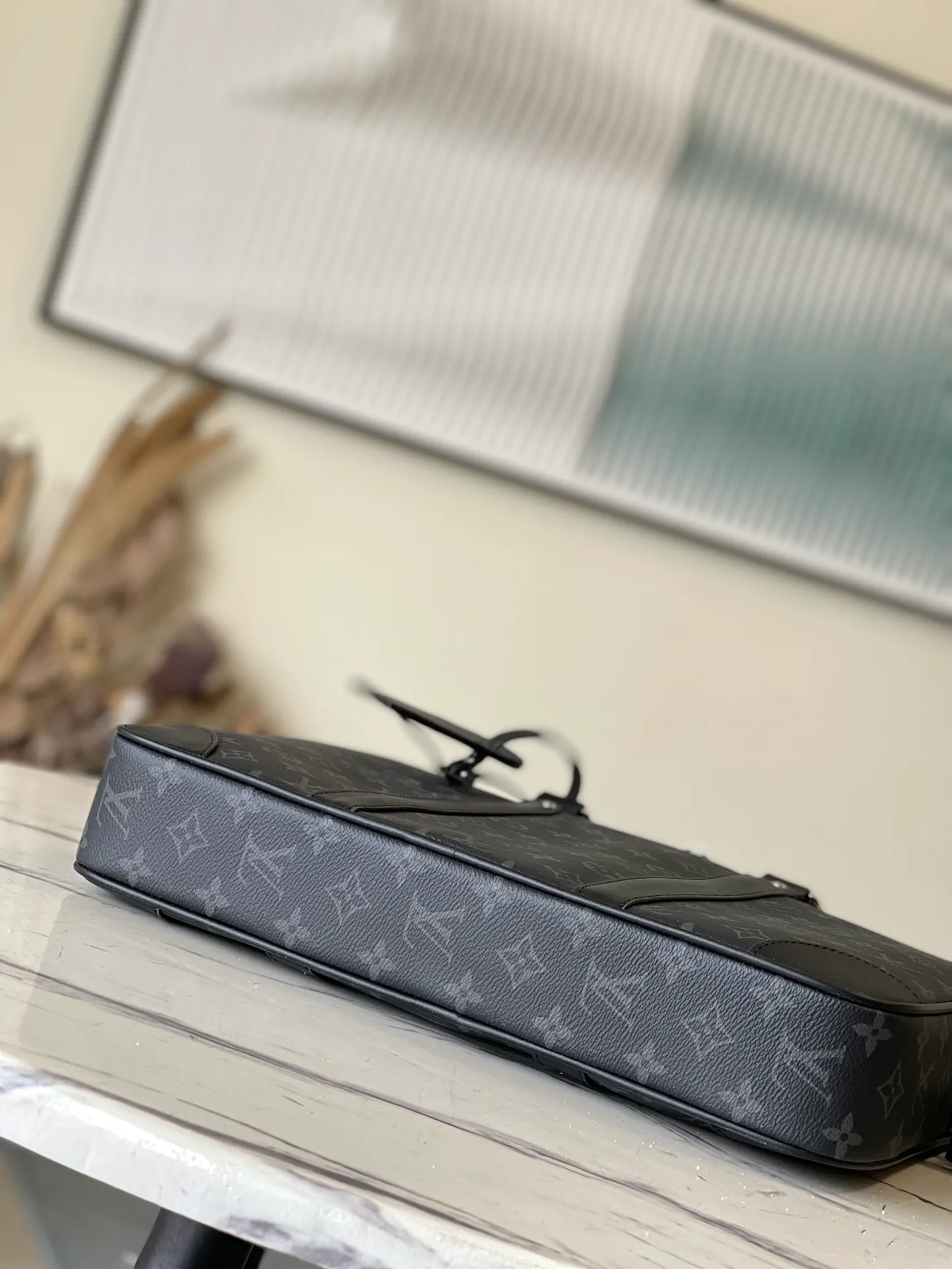 💰1000 Top Original M46457 This Voyage small briefcase is made of Damier Graphite coated canvas, with leather side straps, reinforced corners, top handles and nameplate. The outer pocket makes it easy to store a smartphone, the padded interior compartment holds a 13-inch laptop, and the removable and adjustable shoulder strap makes it comfortable to carry over the shoulder. Dimensions: 36.5 x 27.5 x 6 cm