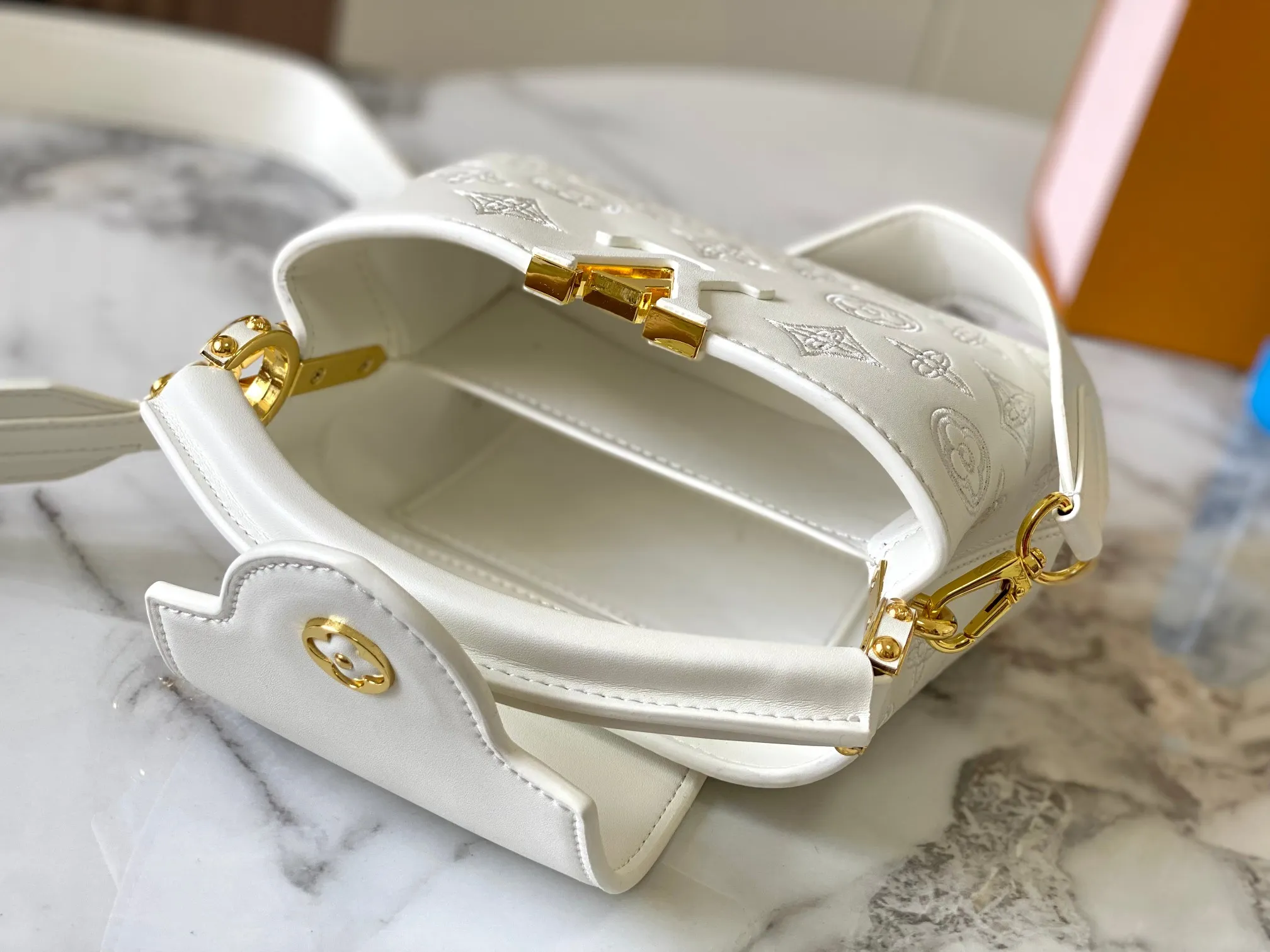Upgraded version P440 M20741 Bourdon stitch embroidered gold buckle This Capucines mini handbag comes from the LV Broderie Anglaise capsule series designed by Nicolas Ghesquière, which transfers the embroidery technology in the ready-to-wear series to this. For the first time, the Monogram pattern appears on cow leather through cutting, and is embellished with Bourdon stitching, which is exquisitely crafted with craftsmanship.  Detailed features 21 x 14 x8 cm (length x height x width)