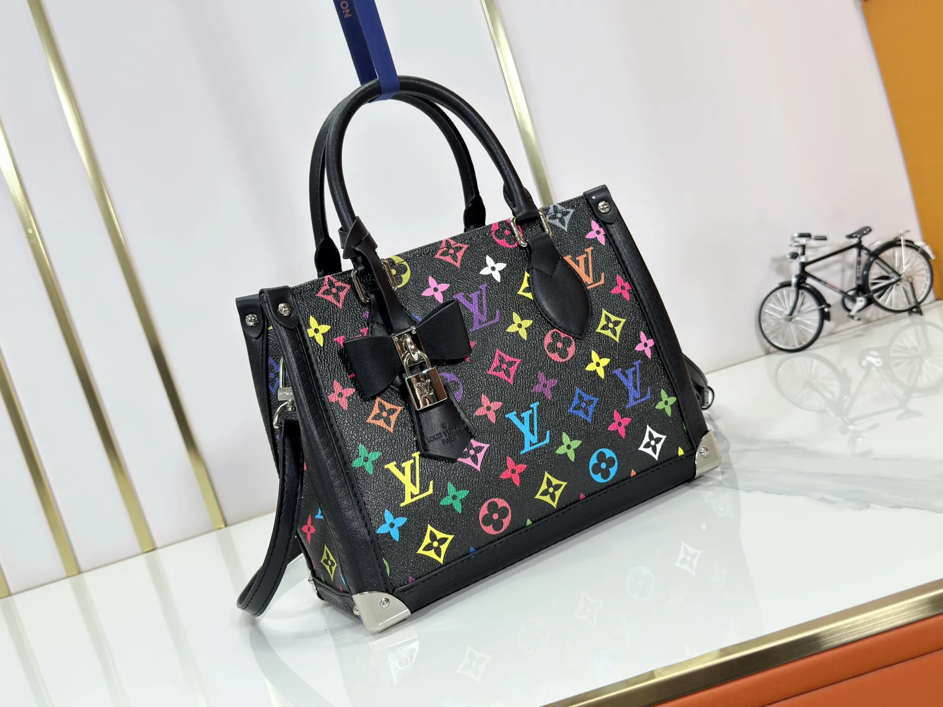 P300 upgraded original M13079 M45495 M45659 M44571 The Louis Vuitton x Murakami reissue series interprets the OnTheGo small handbag in a smart way. The colorful Monogram canvas body, cowhide leather trim and LV x TM key bag highlight the sophisticated style. The shiny corners recall the design of traditional Louis Vuitton luggage, and the shoulder strap and top handle allow for multiple carrying methods. Dimensions: 25.0 x 19.0 x 11.5 cm (length x height x width)