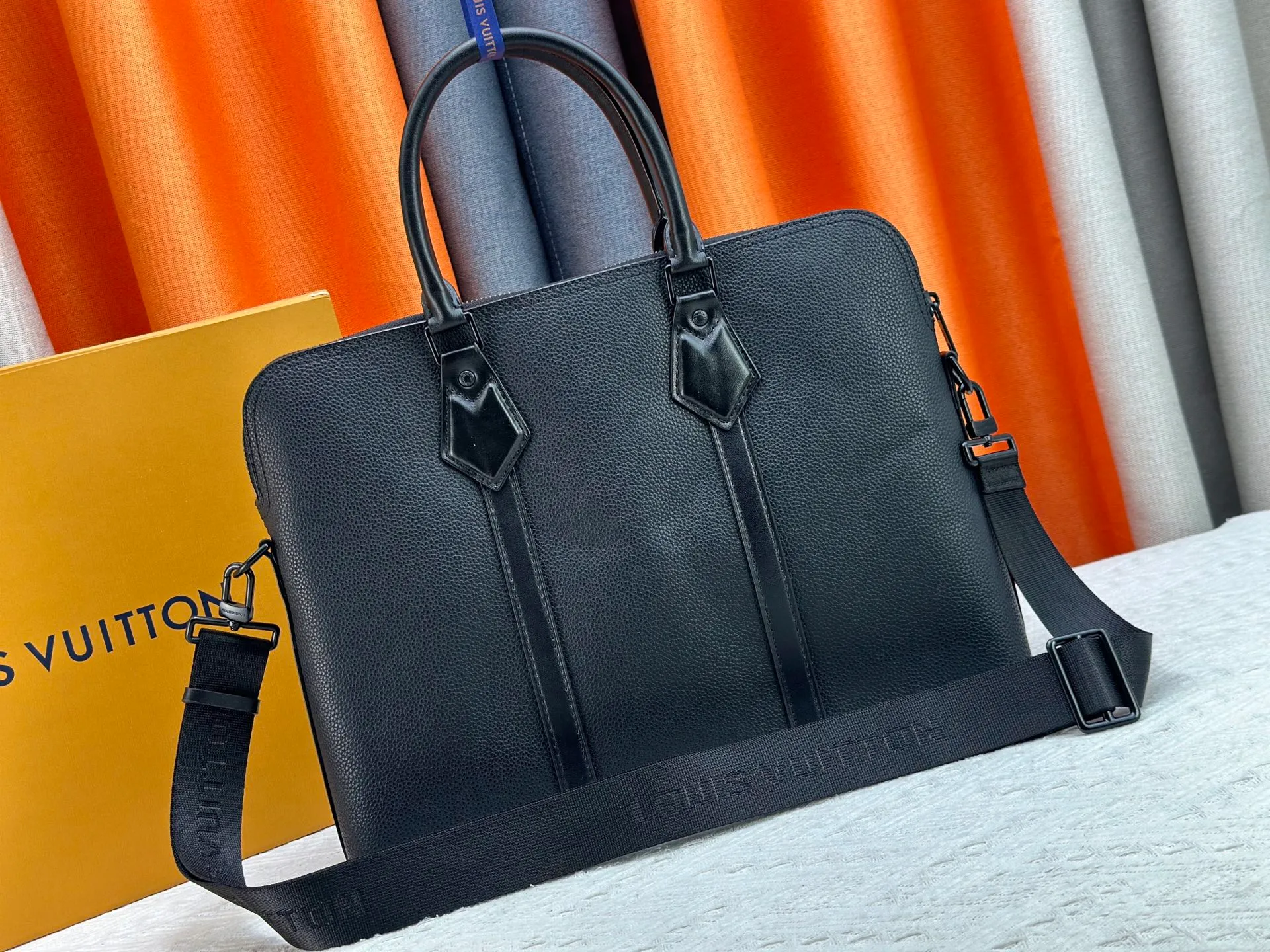 P320 M59159 Black Top Original This briefcase has the soft texture of lv aerogram cow leather, with the metal lv letters emblazoned on the lower right corner. A padded pocket holds a laptop, and the Louis Vuitton logo is sewn into the removable jacquard shoulder strap. 38 x 28x 7cm (length x height x width)