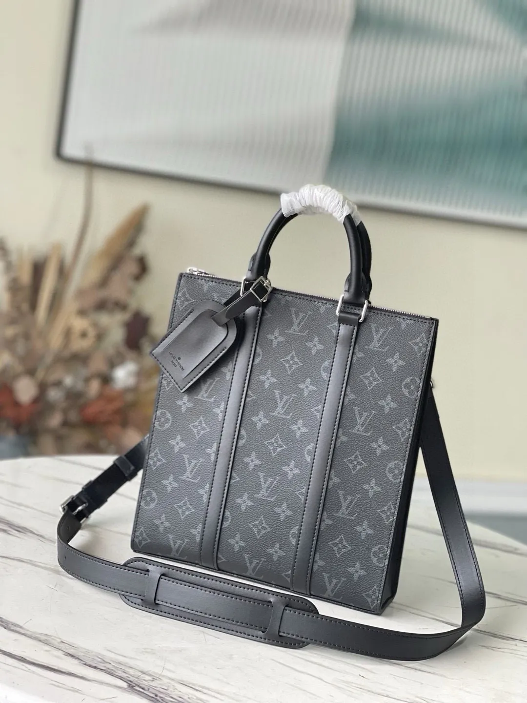 💰1000 Top Original Order M46098 This handbag draws inspiration from the archive Sac Plat handbag, with an elegant structure made of Monogram Eclipse Reserve canvas. Reinforced leather straps and nameplate remain traditional details, and a wide zippered mouth is featured. Detachable shoulder strap provides multiple carrying options. Dimensions: 26 x 28.5 x 6 cm