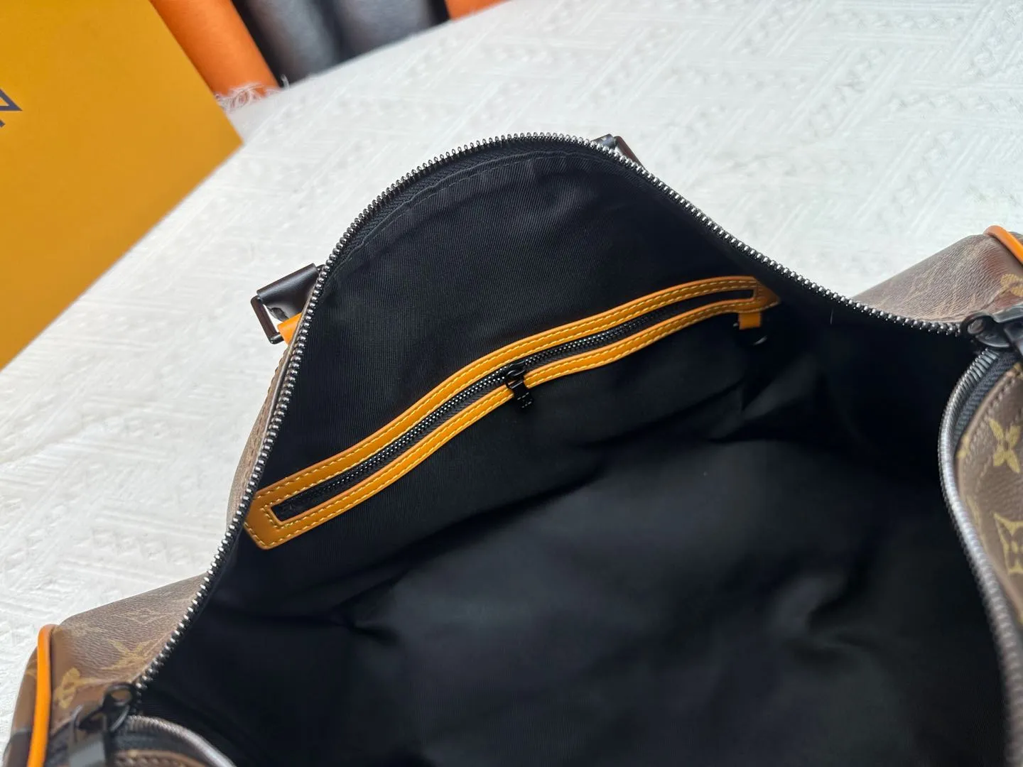 P360 M46703 M41416 This Keepall Bandoulière 45 travel bag introduces classic heritage in Monogram Macassar coated canvas. Side straps are cut out of contrasting leather, leather handles and hardware at the top add a calming touch, and the detachable and adjustable fabric shoulder strap is woven with the Louis Vuitton logo. Dimensions: 45 x 27 x 20 cm (Length x Height x Width) - Monogram Macassar coated canvas - Cow leather trim - Textile lining - Metal hardware - Carry-on baggage dimensions - Double zip closure - Padlock - Internal zip pocket - Removable name tag - Shoulder strap: removable, adjustable - Handles: Double handles - This product is made in one of France, Spain, Italy and the United States