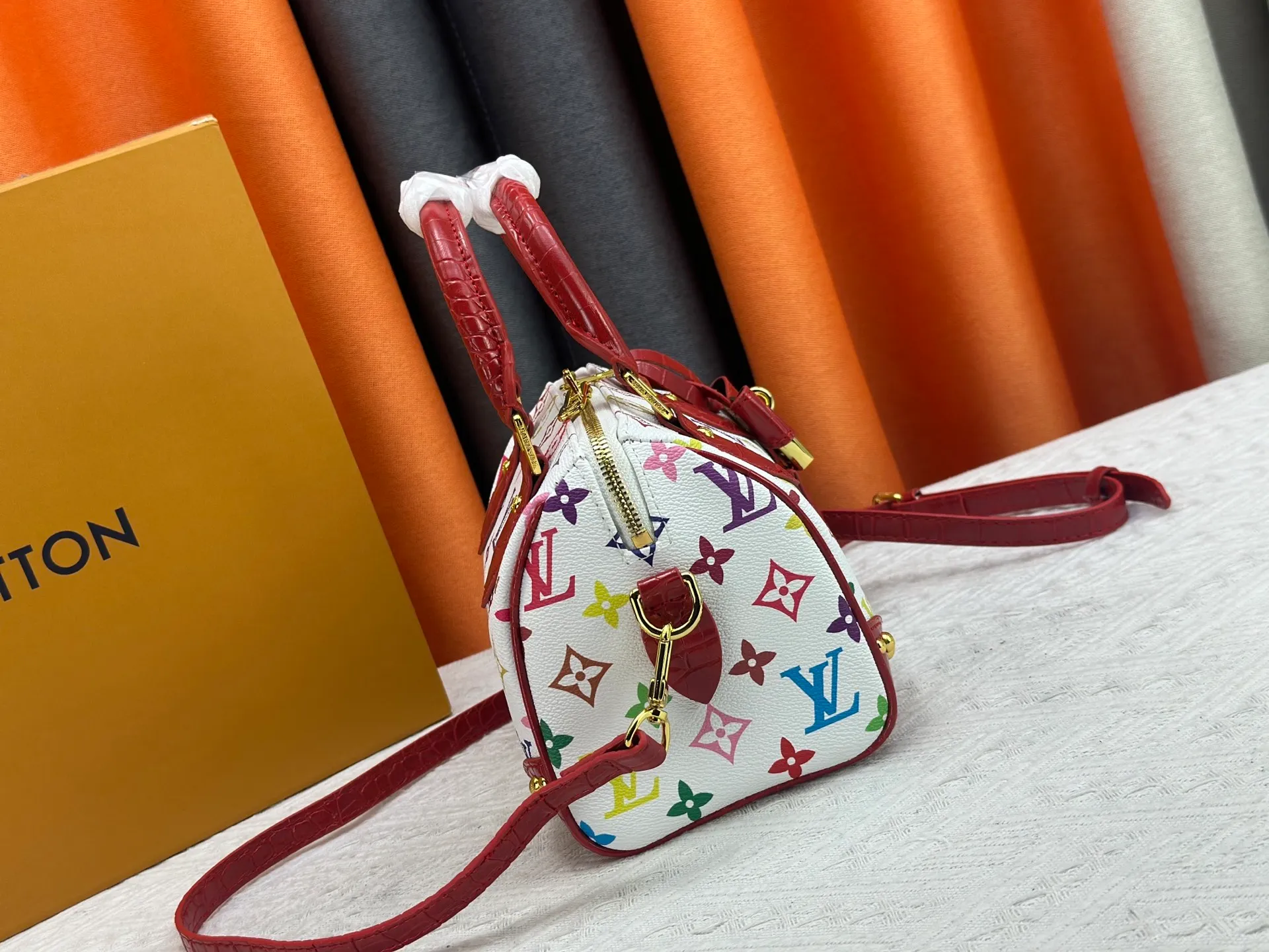 P260 Upgraded original crocodile pattern M13365 M58953 M46234 M46222 Speedy Bandoulière 20 handbag is made of soft coated canvas, and the full-length Monogram pattern is traced in colorful rainbow tones, highlighting the smart style of the Louis Vuitton x Murakami reissue series. The Toron handle and detachable shoulder strap are constructed of cow leather, the metal corners recall classic luggage elements, and the bow-shaped key bag and padlock add brand touches. Dimensions: 20.5 x 13.5 x 12.0 cm (length x height x width)