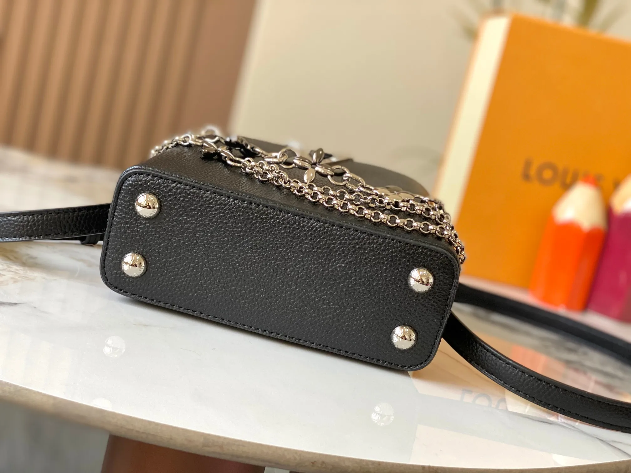 P480 [Guangzhou top quality original version] M26351 Black Silver This modern version of Capucines mini is made of timeless Taurillon leather and equipped with a jewelry-inspired Infinity chain. The bag is decorated with double galvanized metal parts, including the iconic Monogram floral pattern, and the LV Initials logo created with sunburst technology, creating a sundial-like light and shadow effect. The bag has multiple pockets and a detachable shoulder strap, allowing it to be carried on one shoulder or across the body. 14 x 8 x 21 cm (height x width x length)