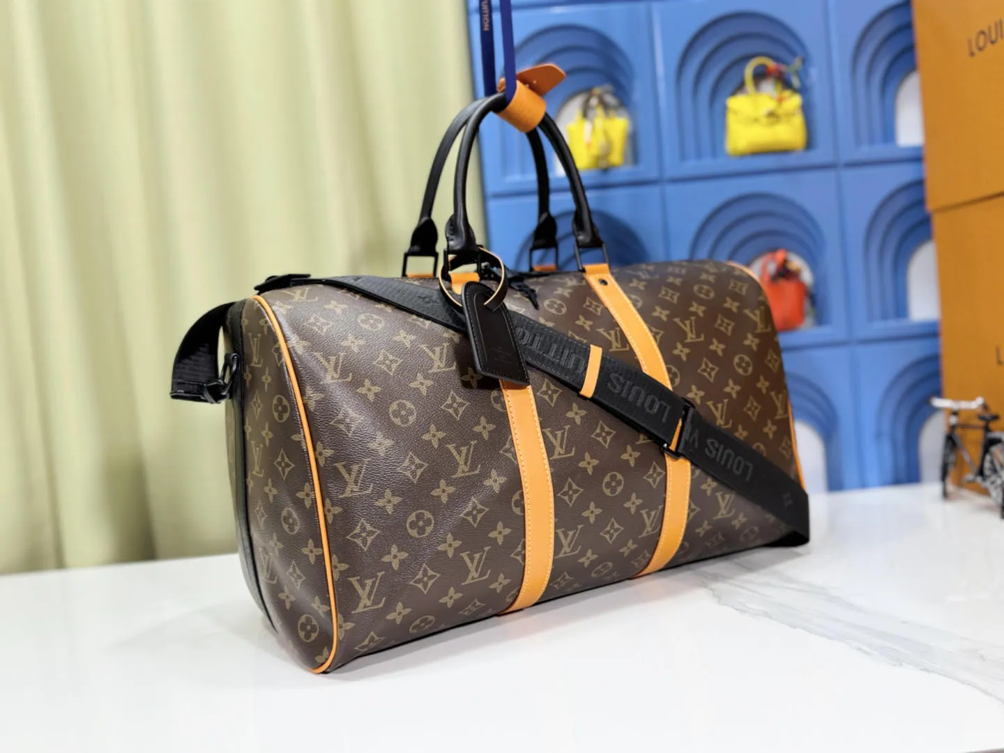 P340 M46703 45cm M46702 55cm Upgraded version This Keepall Bandoulière 45 travel bag introduces classic heritage with Monogram Macassar coated canvas. Side straps are cut out of contrasting leather, leather handles and hardware at the top add a calming touch, and the detachable and adjustable fabric shoulder strap is woven with the Louis Vuitton logo. 45.0 x 27.0 x 20.0 cm (L x H x W) • Monogram Macassar coated canvas • Cow leather trim • Textile lining • Metal hardware • Carry-on dimensions • Double zip closure • Padlock • Internal zip pocket • Removable name tag • Shoulder strap: removable, adjustable • Half-length strap: 36.0 cm • Half-length strap adjustable to: 50.0 cm • Handle: Double handle