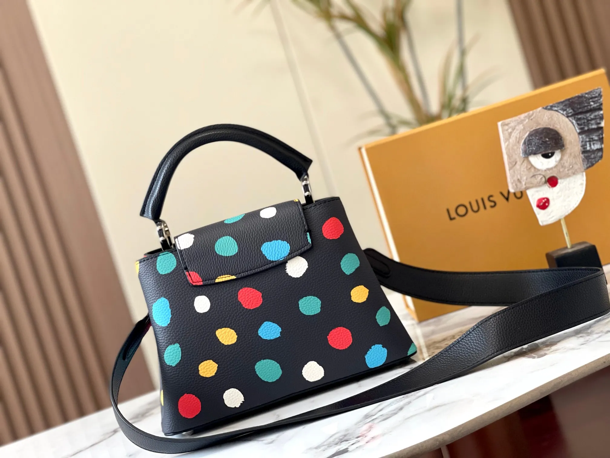 Upgraded version P440 M21663 This LV x YK Capucines small handbag comes from the Louis Vuitton x Yayoi Kusama collaboration series. The renowned Japanese artist has been obsessed with polka dots as a symbol of infinity since childhood, and finds a dazzling expression in supple Taurillon leather decorated with 3D hand-painted polka dot prints. Detailed features 27 x 18 x 9 cm (length x height x width)