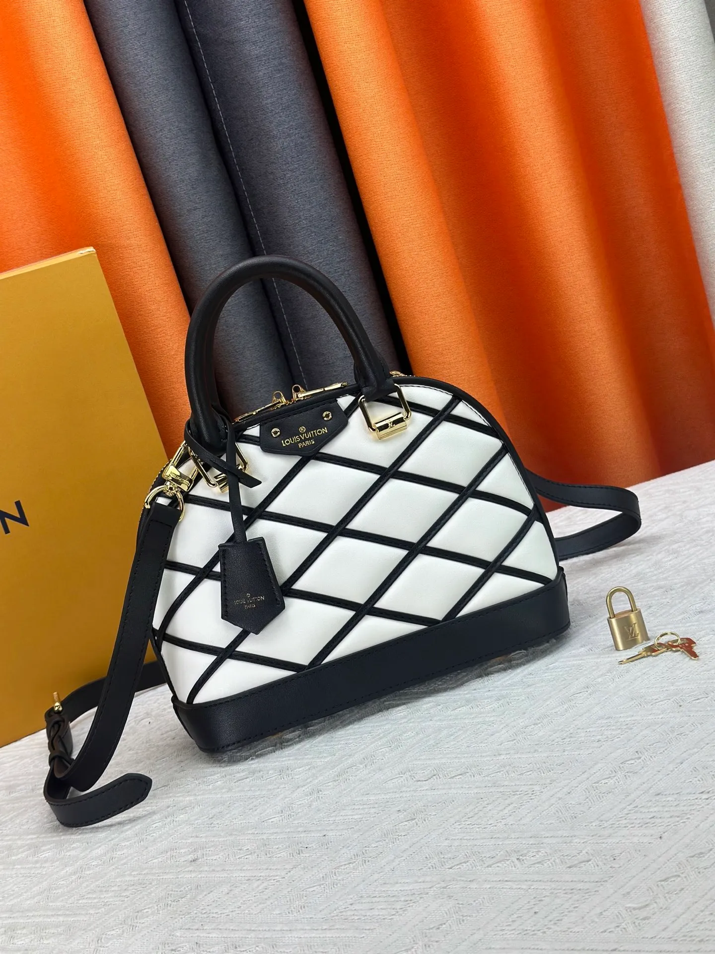 P360 M83048 M53152 This Nano Alma handbag is a pocket-sized version of Louis Vuitton's classic Alma handbag. It is made of soft lambskin with a Malletage quilting pattern, recalling the diamond inner panel of the brand's traditional hard luggage. The elegant handle, dazzling chain and detachable and adjustable leather shoulder strap enable a variety of carrying styles. Dimensions: 23.5x17.5x11.5cm