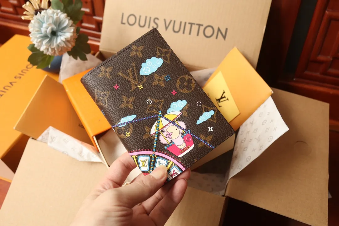 P260🎉Original order🎉M69746 [Chigua][Chigua] 2020 Christmas limited edition passport cover is made of Monogram canvas, showing the joyful scene of Louis Vuitton mascot Vivienne riding the Ferris wheel. It combines classic elements such as LV letters and Monogram flowers, making it a good choice for holiday gifts. Dimensions: 10.0 x 14.0 x 2.5.