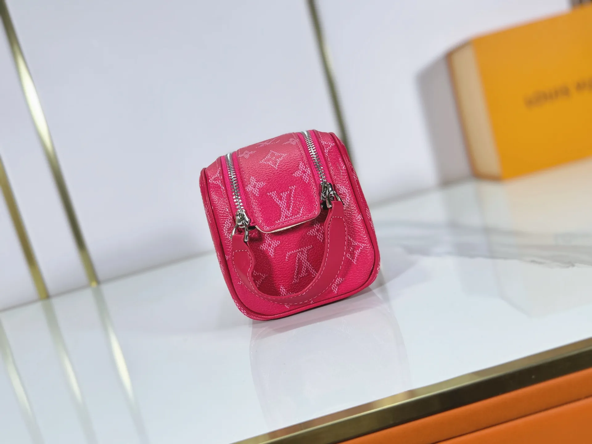 P180 Upgraded original M26872 M27158 M26871 M26870 This Dopp Kit mini toiletry bag is made of brightly colored Monogram Heritage coated canvas with cow leather details. The double-zipper wide-mouth closure makes it easy to access toiletries, and the washable fabric lining adds functionality. Dimensions: 20 x 13 x 12 (cm) ((length x height x width)