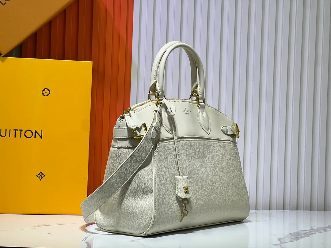 Batch 340💰M11214 green M22914 black M22925 brown M23061 off-white M22927 taupe. Sophisticated and functional, the Lock It MM bag is crafted in fine grained Taurillon leather and smooth calfskin, with gold-finish buckles and hardware. Signature House touches include padlocks, key bells and hot-stamped Louis Vuitton signatures. Featuring an articulated top handle and removable strap, this tote offers a variety of carrying options. 36x29x15 cm (LxHxW) Black Taurillon leather, smooth calfskin semi-leather trim Microfiber lining Gold hardware 2 square buckles padlock key bell External pockets 2 internal flat pockets Internal zipped pocket with flat pockets 5 protective metal studs Strap: removable, adjustable Strap drop: 45.0 cm Maximum strap drop: 51.0 cm