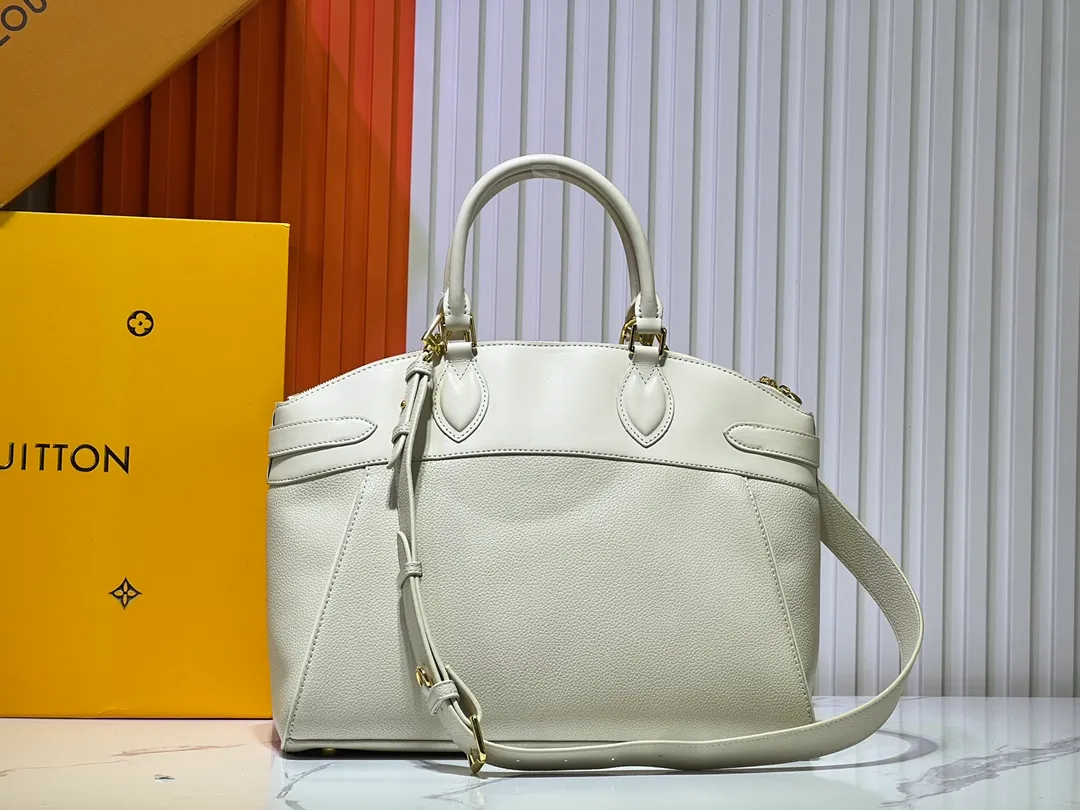 Batch 340💰M11214 green M22914 black M22925 brown M23061 off-white M22927 taupe. Sophisticated and functional, the Lock It MM bag is crafted in fine grained Taurillon leather and smooth calfskin, with gold-finish buckles and hardware. Signature House touches include padlocks, key bells and hot-stamped Louis Vuitton signatures. Featuring an articulated top handle and removable strap, this tote offers a variety of carrying options. 36x29x15 cm (LxHxW) Black Taurillon leather, smooth calfskin semi-leather trim Microfiber lining Gold hardware 2 square buckles padlock key bell External pockets 2 internal flat pockets Internal zipped pocket with flat pockets 5 protective metal studs Strap: removable, adjustable Strap drop: 45.0 cm Maximum strap drop: 51.0 cm
