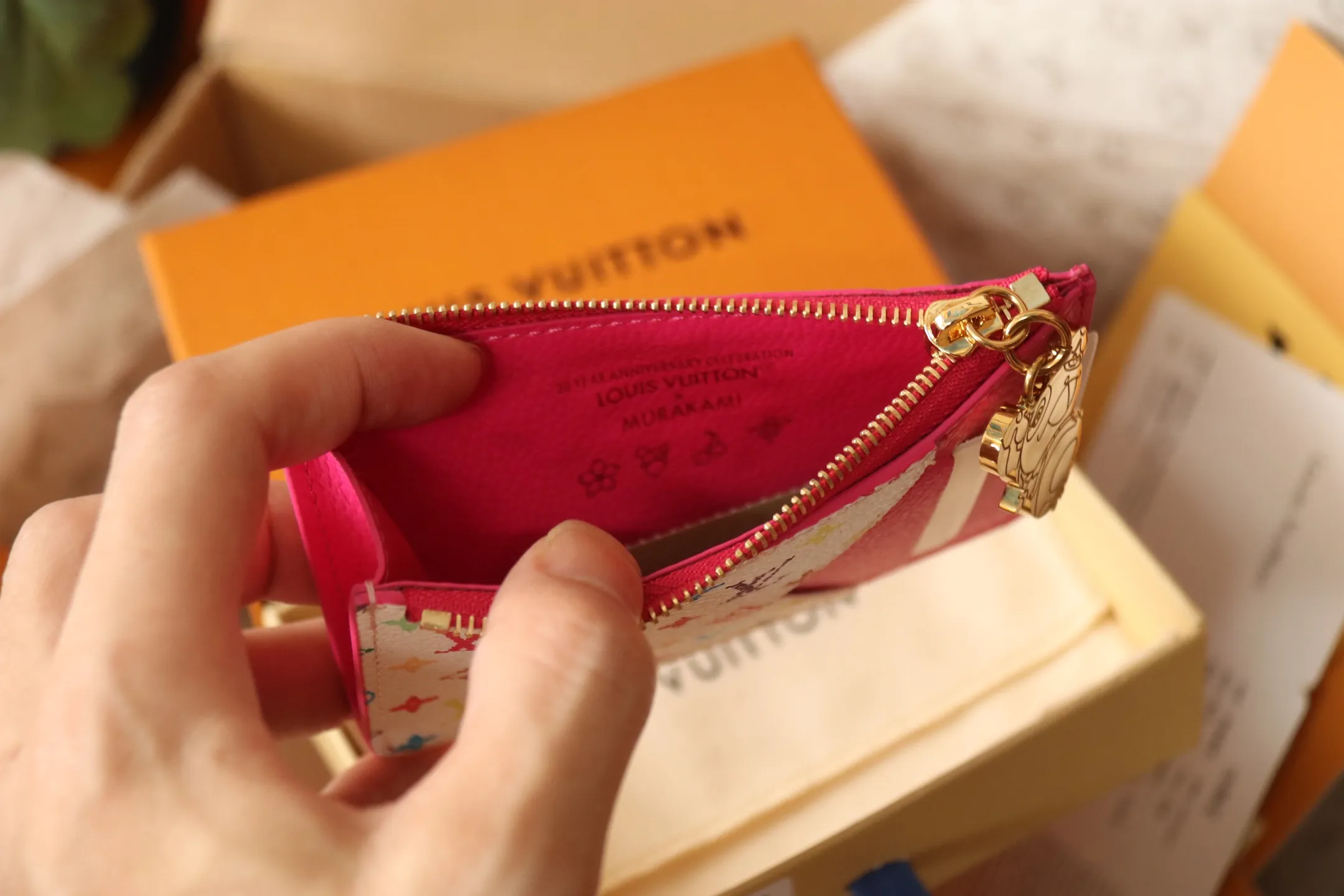 【LV x TM Romy Card Holder】 💎P400 m14155 Rose m14171 Blue m13800 Green "LV × TM Porto Kurt Romy" appears in the "Louis Vuitton × Takashi Murakami" series that unfolds in a variety of categories. It features functional and playful expressions with fresh tones inspired by the rainbow colors unique to Japanese artists. The whole piece is finished with Monogram Amplant leather that adds a casual personality, and the bright Monogram multi-color canvas in the flat pocket stands out. The coin pocket opens and closes with a gold zipper and features a panda pull to symbolize the season.  Dimensions: 12 x 8 x 0.8 cm