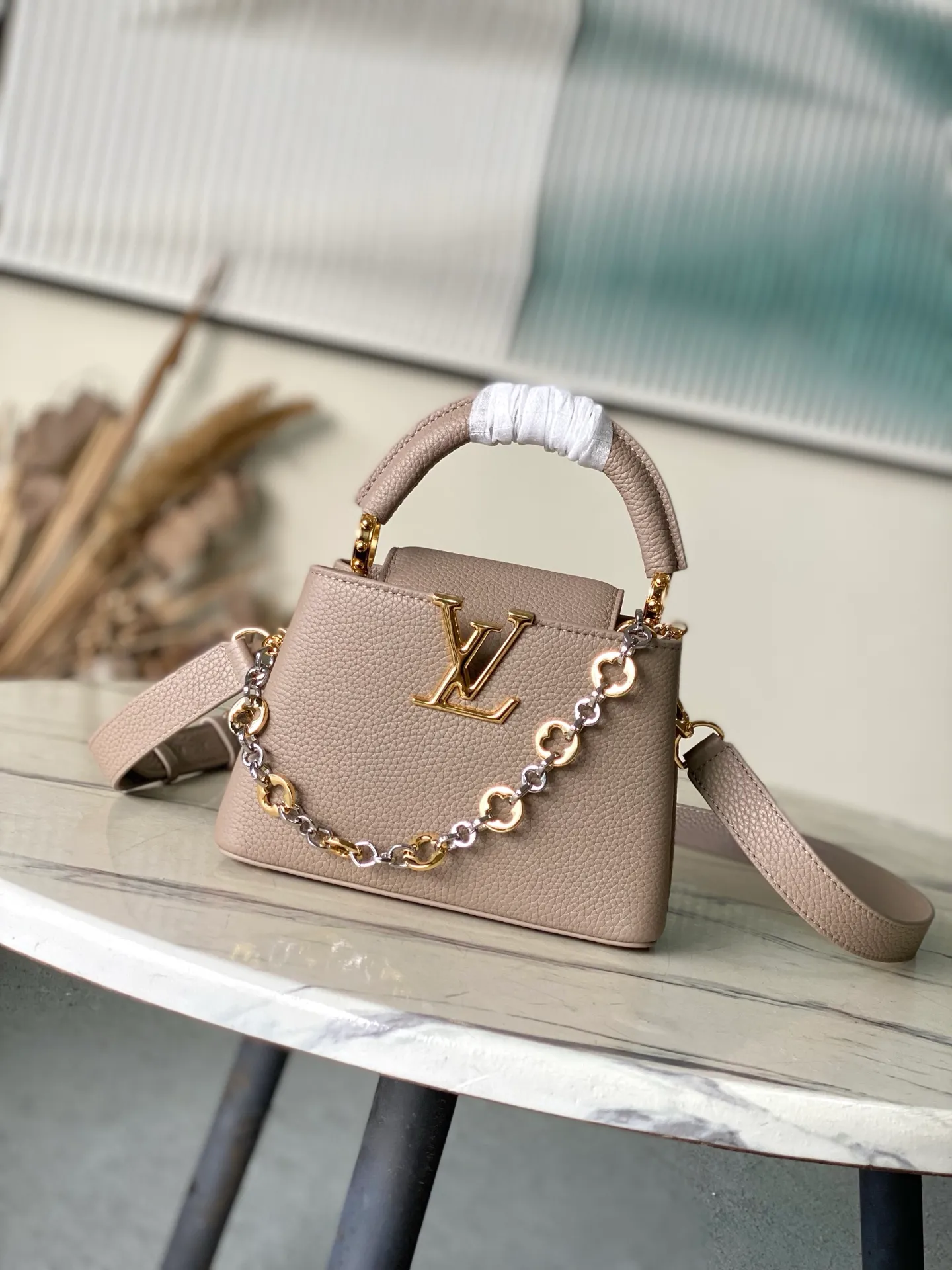 💰2180 "Special Grade Original Leather" M12935 Elephant Gray Mini This Capucines mini handbag is made of flexible Taurillon cow leather. It uses jewelry-style double-plated chains and Monogram floral elements to highlight the identity of the Chain On You series. The flip cover can be placed on both the inside and outside. The ample structure and multiple inner pockets are convenient for storing daily needs. The rounded V letter adds an ingenious detail. Dimensions: 21 × 13.6 × 8 cm