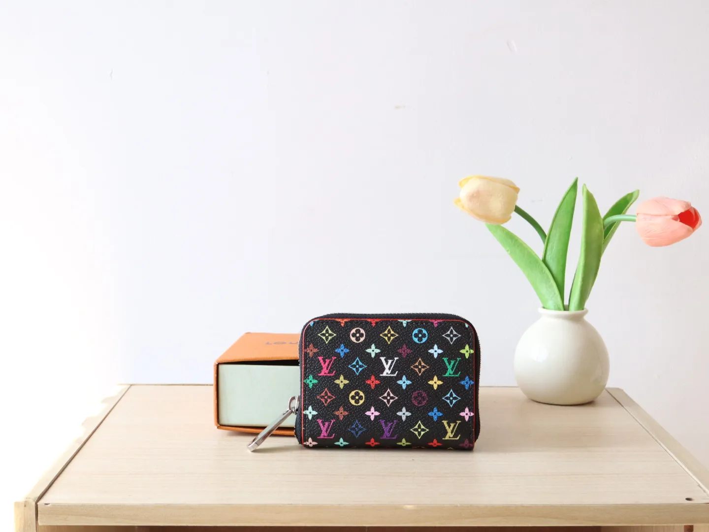 13409 Tricolor Short Zipper Style 🌟P88 LV x TM Zippy Coin Purse M13409 White Color (Tricolor - Murakami) As part of the Louis Vuitton x Murakami series reissue, the timeless Zippy coin purse is practical and playful, upgraded for this season. It's made from Monogram coated canvas in a cheerful rainbow of hues, in keeping with the Japanese artist's signature pop palette. The interior is secured with a silver zipper and is divided into multiple compartments for coins, banknotes and cards. Dimensions: 11 x 8.5 x 2 cm.