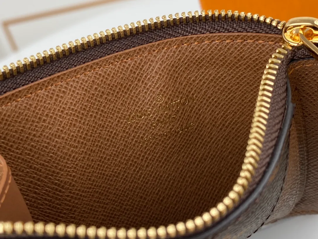 Factory price 240. This multifunctional Romy business card holder M81882 in presbyopia and brown is full of modern fashion. It has the simple design of a business card holder and the practicality of an accordion zipper pocket. It is very suitable for storing scattered cash, change or receipts. The new style is crafted in Monogram canvas, lined with colorful leather and finished with the iconic LV Circle zipper pull in gold-tone metal.