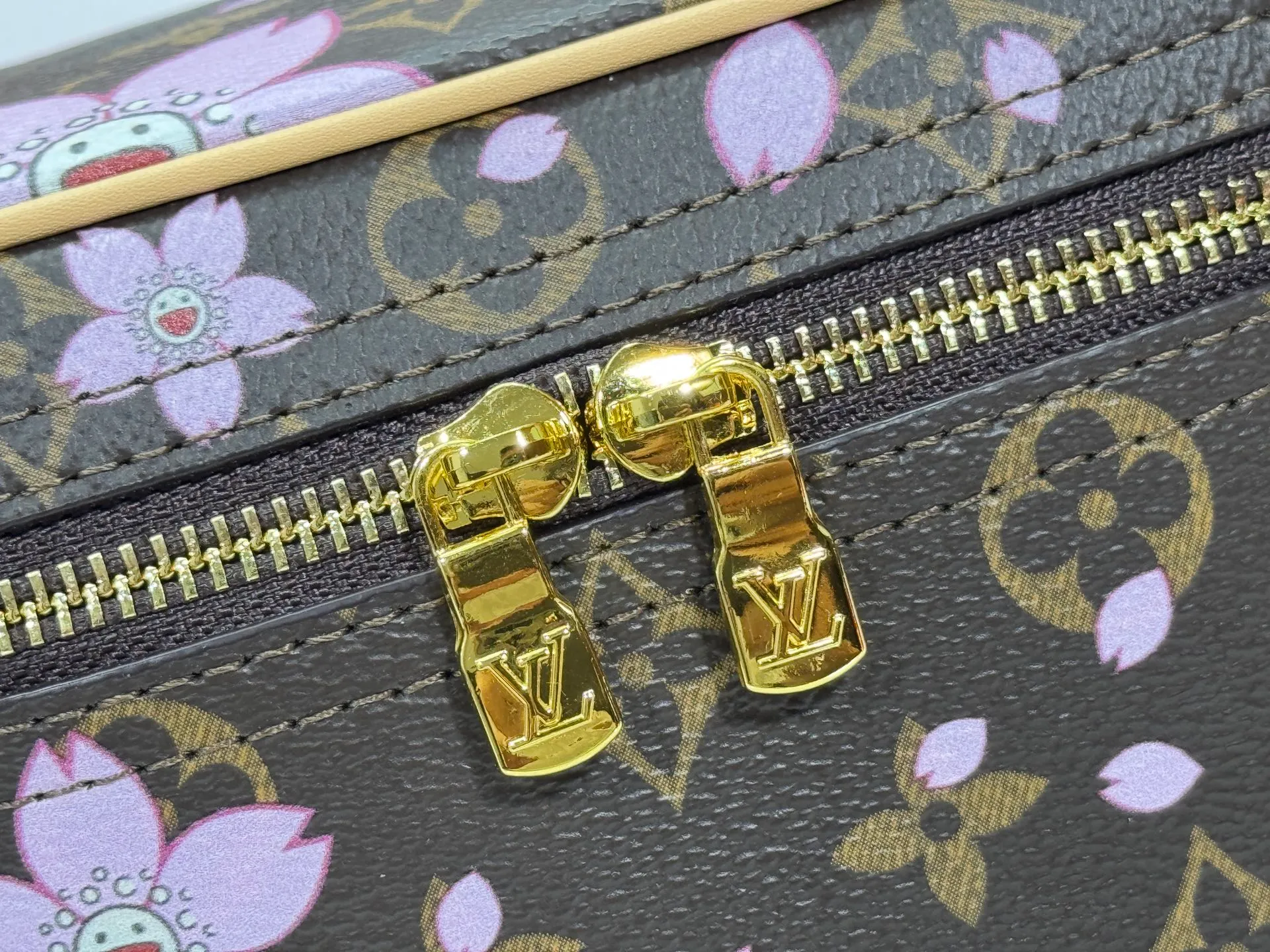 P240 Upgraded original M14181 M44495 This Nice mini cosmetic bag is made of Monogram coated canvas. The box-shaped outline is condensed with rounded strokes. The Cherry Blossom pattern releases the joyful atmosphere of the Louis Vuitton