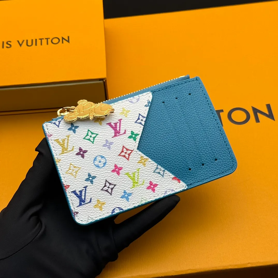 💰140 💎Top Original #Blue 🇫🇷 This Romy card holder is from the Louis Vuitton x Takashi Murakami cross-border collaboration series, rendering fresh colors in Monogram Empreinte leather, subtly paying tribute to the rainbow tones painted by Japanese artists. Colorful Monogram coated canvas accents the patch pockets, and the panda-shaped zipper pull of the zippered coin bag adds new season interest. Model: M13800 Dimensions: 8 x 0.8 x 12 cm (H x W x Length)