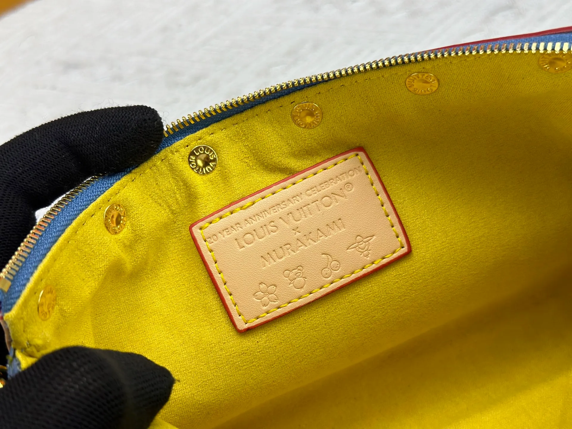 P230 M13404 Denim Denim This Pochette Accessoires handbag is made of coated canvas and uses colorful Monogram patterns to interpret the smart style of the Louis Vuitton x Murakami cross-border collaboration series. Calf leather trim and dazzling hardware add to the sophisticated details, while the detachable shoulder strap and chain provide flexible carry. Size: 22x13x4cm