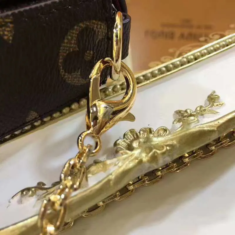 P140 Model: 61276 Size 21/11/2 Introduction: The Louis vuitton Felicie three-piece handbag is elegant and luxurious. It contains two detachable pockets and is a fashionable choice for carrying and organizing your daily necessities. It is more than just a wallet, after removing the gold chain, it can also be used as a charming clutch or small handbag ""