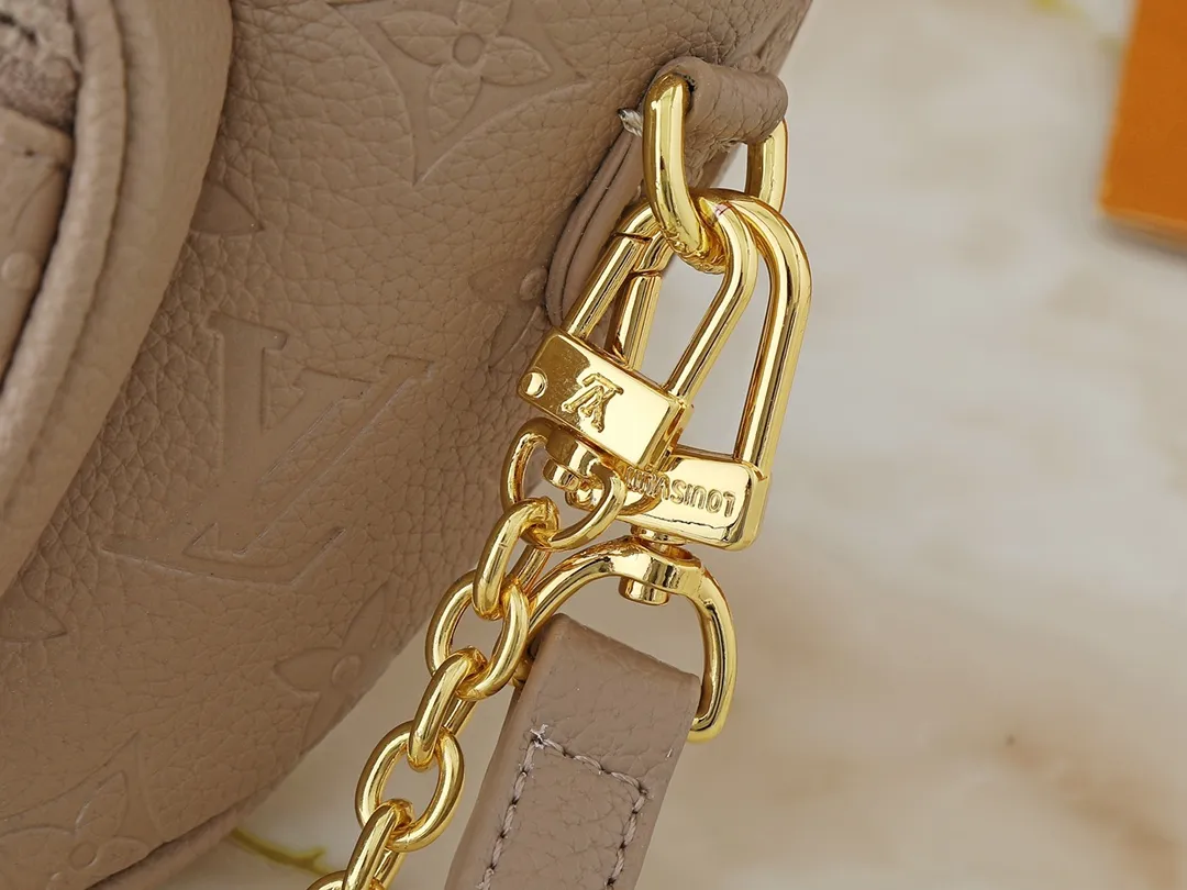 💰200💰Upgraded from the original M46917 M82335 M83275 M82208 M82347 This Mini Bumbag handbag comes from the LV Gradient series and uses the Monogram embossing of Monogram Empreinte leather to render gradient midsummer colors. The on-trend construction features a zipped main compartment and a front pocket with a Louis Vuitton leather label. With the detachable chain and detachable and adjustable shoulder strap, it can be worn as a shoulder or cross-body bag. 17.0 x 12.0 x 9.5 cm (L x H x W) • Monogram Empreinte embossed soft-grained cowhide leather • Textile lining • Metal hardware • Zip closure • Zip front pocket • Shoulder strap: removable, adjustable • Half-length strap: 32.0 cm • Half-length strap adjustable to: 44.0 cm • Chain: Removable • Half-length chain: 20.0 cm