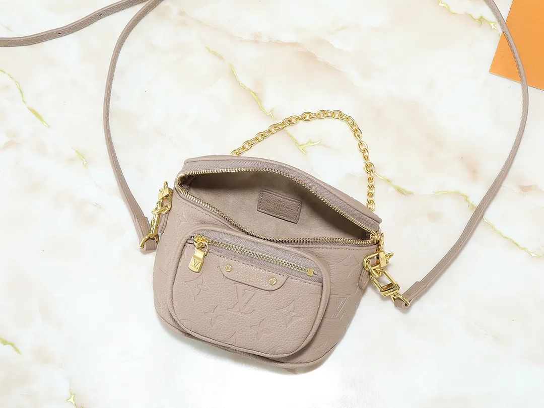 💰200💰Upgraded from the original M46917 M82335 M83275 M82208 M82347 This Mini Bumbag handbag comes from the LV Gradient series and uses the Monogram embossing of Monogram Empreinte leather to render gradient midsummer colors. The on-trend construction features a zipped main compartment and a front pocket with a Louis Vuitton leather label. With the detachable chain and detachable and adjustable shoulder strap, it can be worn as a shoulder or cross-body bag. 17.0 x 12.0 x 9.5 cm (L x H x W) • Monogram Empreinte embossed soft-grained cowhide leather • Textile lining • Metal hardware • Zip closure • Zip front pocket • Shoulder strap: removable, adjustable • Half-length strap: 32.0 cm • Half-length strap adjustable to: 44.0 cm • Chain: Removable • Half-length chain: 20.0 cm