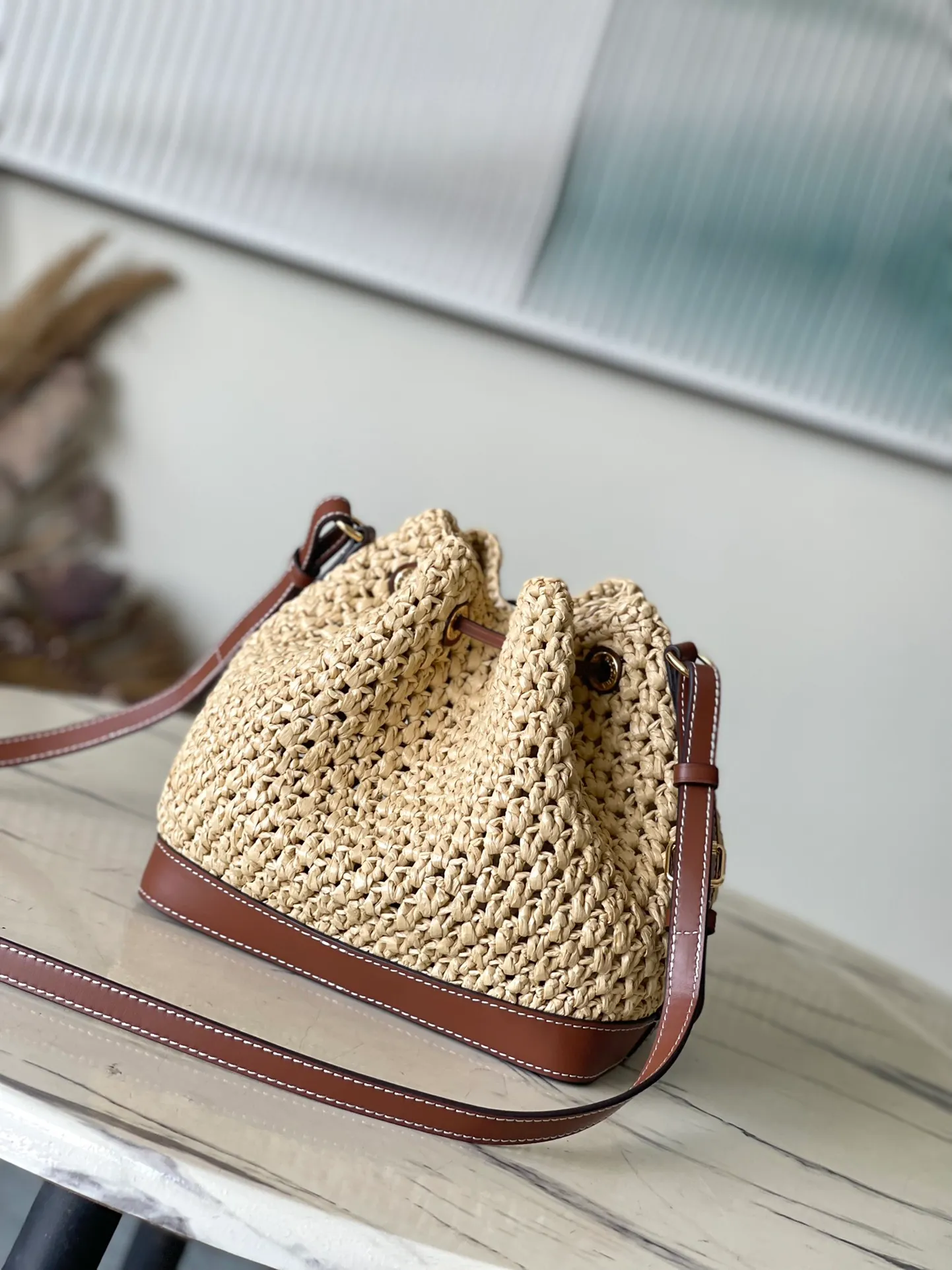💰1100 Top Original Order M24722 This NoeBB bucket bag is made of raffia crocheted by Madagascar craftsmen. It is decorated with gorgeous leather to highlight the brand's exquisite craftsmanship, achieving a comfortable texture and personalized style. Dimensions: 22 × 24 × 15 cm