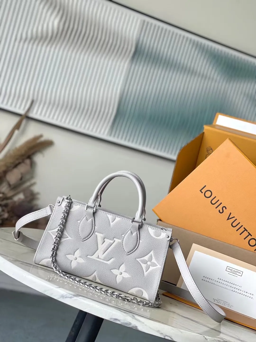 💰1060 (top-grain leather) top original order M14213 This OnTheGo East West handbag is from the LVMilky Way series. The iconic Monogram Empreinte leather is dyed with seasonal colors, complementing the shiny metal parts and detachable braided chain. The inner and outer compartments can store daily necessities in an orderly manner. The compact structure is easy to carry in a variety of ways. Dimensions: 25 × 13 × 10 cm
