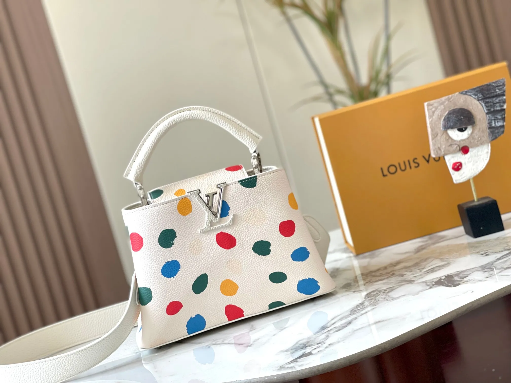 Upgraded version P440 M21663 This LV x YK Capucines small handbag comes from the Louis Vuitton x Yayoi Kusama collaboration series. The renowned Japanese artist has been obsessed with polka dots as a symbol of infinity since childhood, and finds a dazzling expression in supple Taurillon leather decorated with 3D hand-painted polka dot prints. Detailed features 27 x 18 x 9 cm (length x height x width)