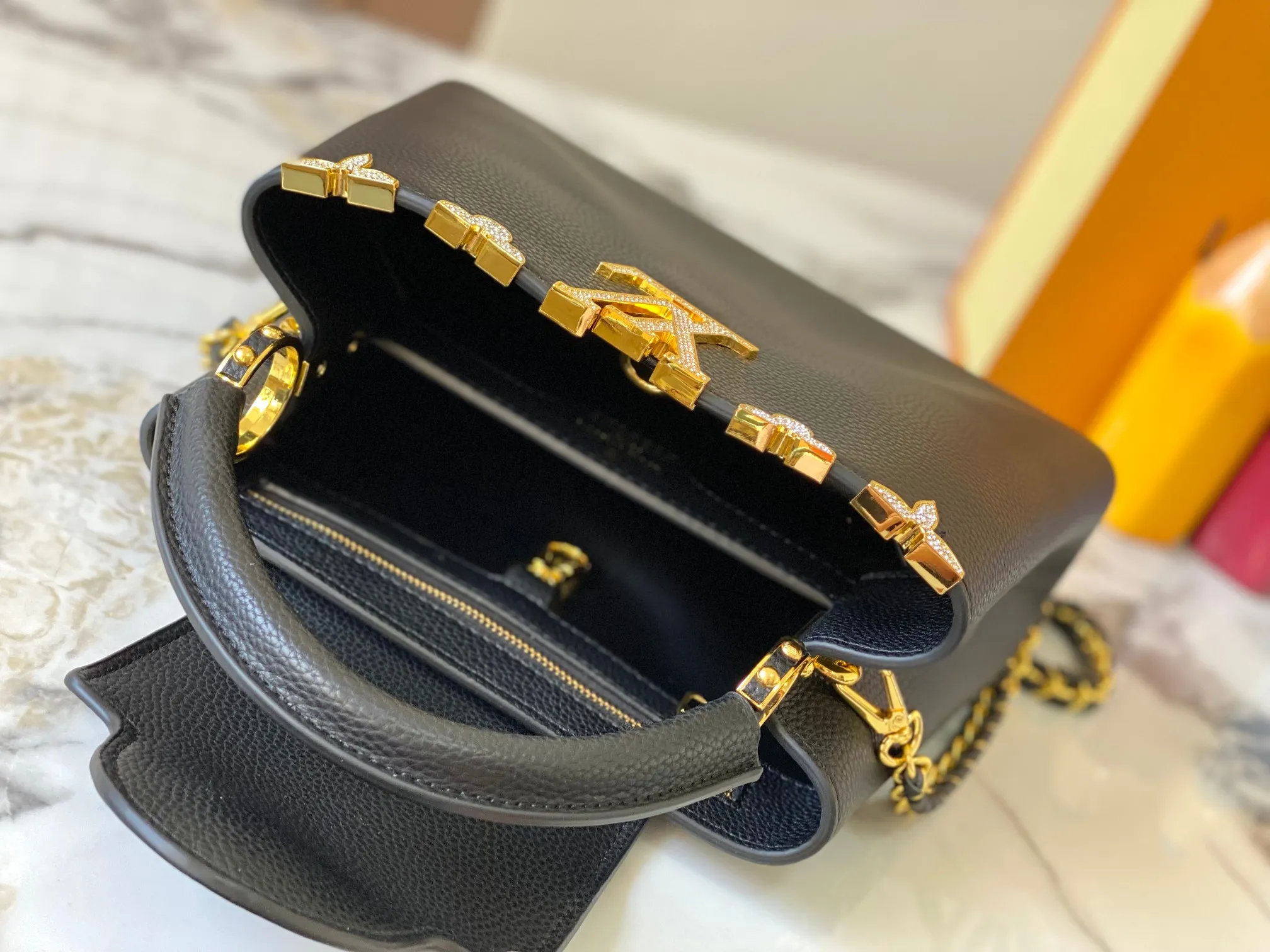 Top original P460 Guangzhou product M24584 black gold and diamond corolla 🔺This Capucines Flower Crown handbag is made of full-grain Taurillon leather embellished with Monogram flowers. Each flower is shaped by exquisite crystal diamonds. The LV logo and flowers echo each other, giving this feminine handbag a jewel-like luster. Use the detachable shoulder strap skillfully to switch between shoulder and crossbody at will♠️Size: 27 * 18 * 9 cm🥂