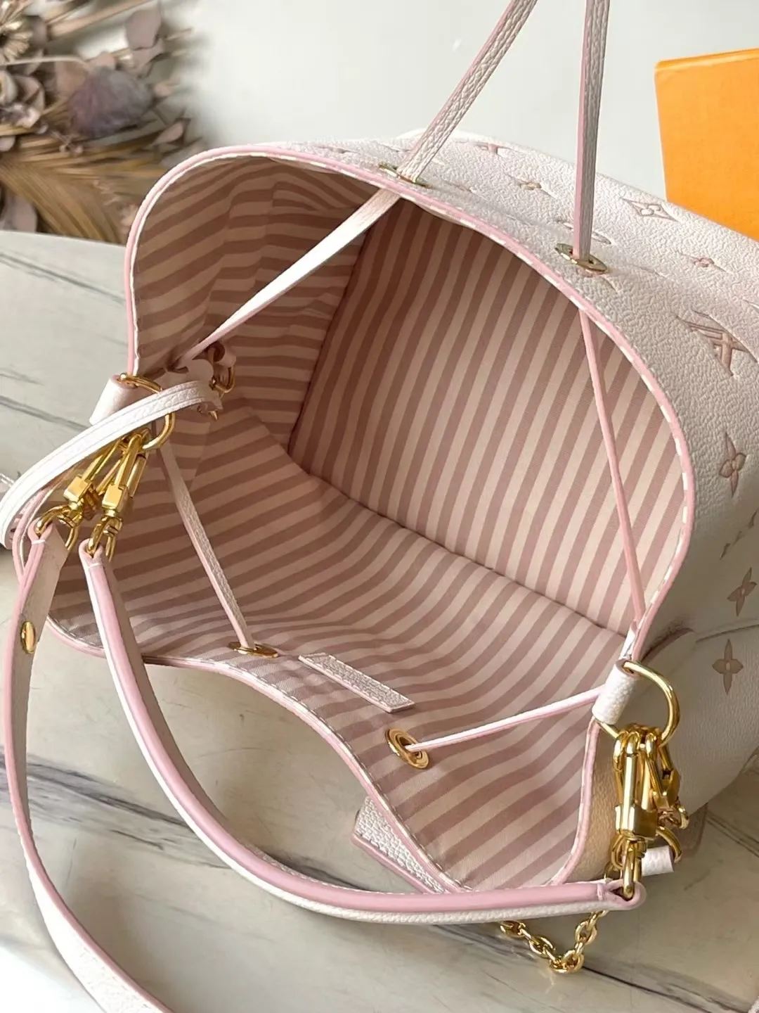 💰1180 (top-grain leather) top original order M14401 This NeoNoe medium handbag uses classic Monogram Empreinte leather to interpret the same color aesthetics, and uses dazzling chain decoration to release the new ideas of the season. The neat interior is equipped with multiple compartments and a removable storage bag for convenient storage of small items. Dimensions: 26 × 26 × 17.5 cm