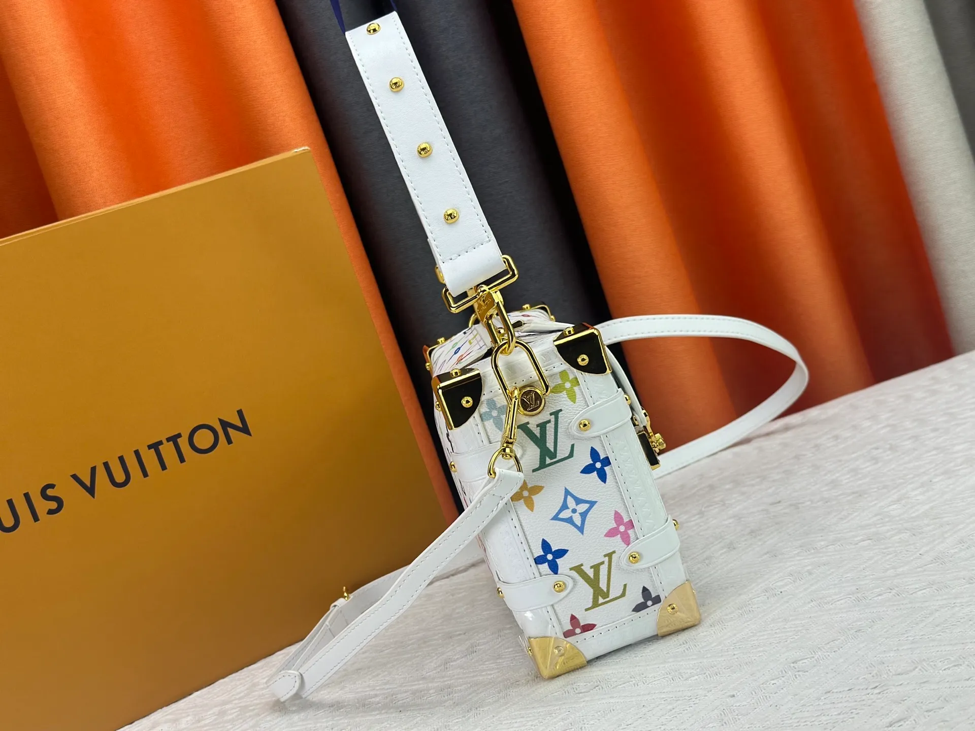 P300 M14046 M46358 Black Tricolor White Tricolor This Side Trunk medium handbag uses a humorous Monogram pattern to express the smart style of Louis Vuitton The square shape is a nod to the brand's classic luggage, and the removable studded handle and shoulder strap allow for flexible carrying. Size: 23.5x16x8.5cm