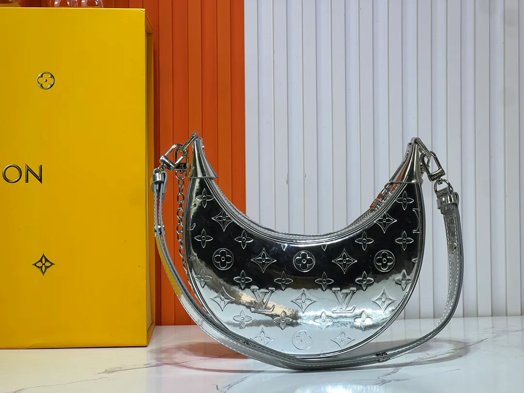 Batch 260💰Upgraded original M11833 M81098 This small Loop handbag is from the LV Ski series. It draws inspiration from the brand’s classic metal hard case in 1892, and renders the Monogram Miroir effect on the Monogram embossed coated canvas, making the traditional aesthetics reveal a retro-futuristic feel. The adjustable leather shoulder strap and chain are detachable, making it a flexible choice for storing essentials and a long wallet when traveling day or night. Dimensions: 23.0 x 13.0 x 6.0 cm (length x height x width)