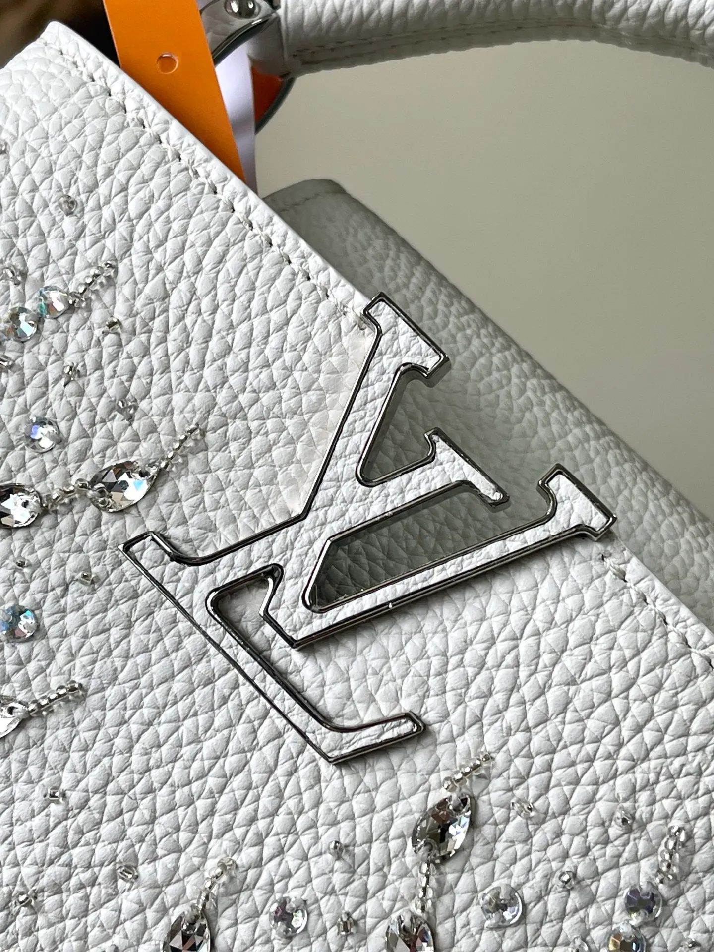 💰2700 "Special Grade Original Leather" M25934 White Mini As part of the "Extraordinary Series", this Capni mini bag has been redesigned with exquisite embroidery technology. It's made from calfskin and embellished with shimmering sequins in a romantic floral pattern and finished with gold-toned hardware. The backpack design provides a separated interior space and features the iconic LV initials as a tribute to the brand's exquisite craftsmanship. Dimensions: 21 x 13.6 x 8cm