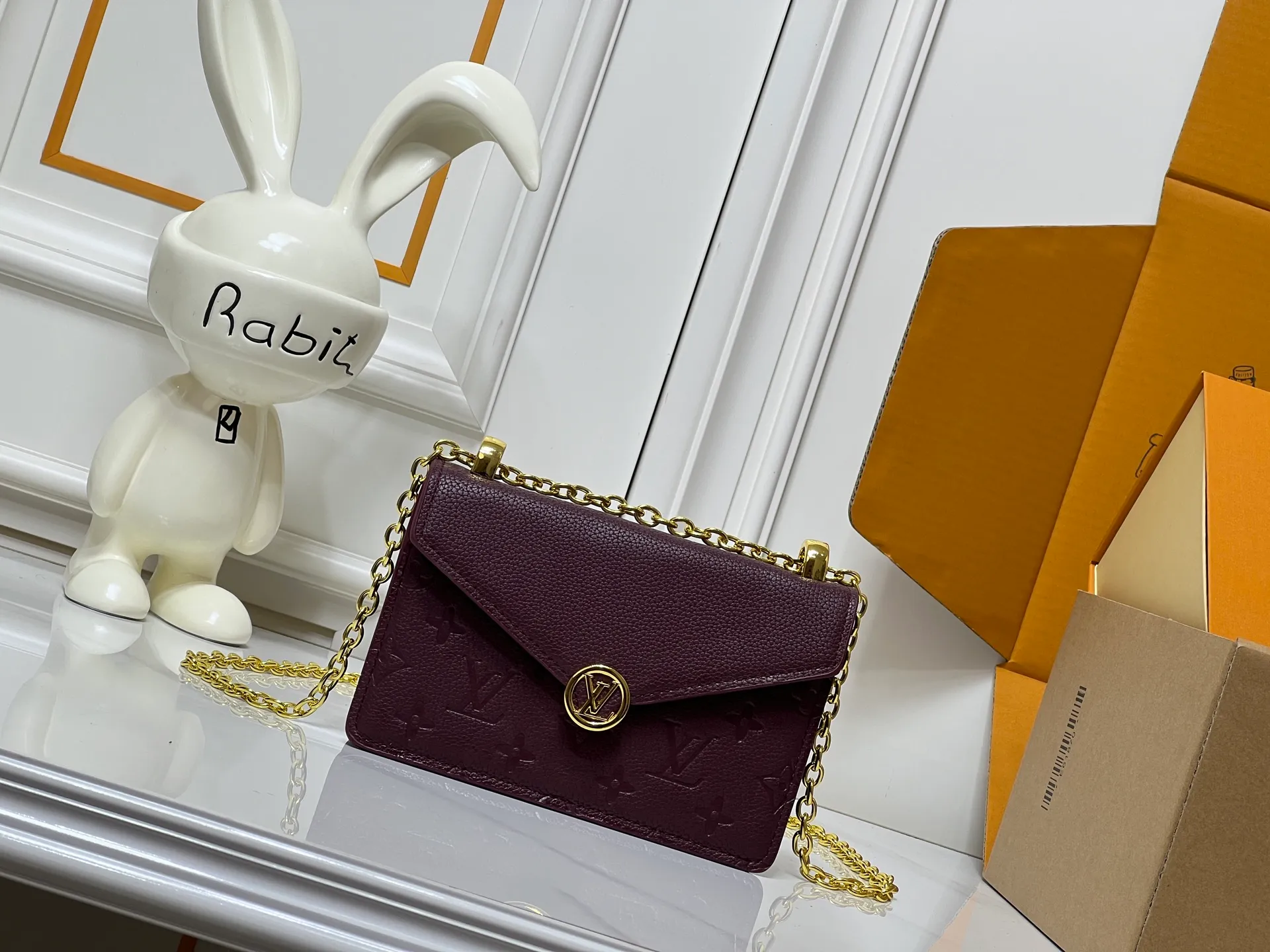 Batch 220💰M13569 black M13570 gray M25814 burgundy (chain/embossed) [Portefeuille chaîne Rosy] This Rosy chain wallet is both fashionable and practical, adding a modern spirit to the Monogram Empreinte series. It has an elegant LV circle and a V-shaped flap, two hallmarks of the house. The magnetic closure reveals a surprise Monogram flower, as well as three card slots and a flat interior pocket. The sliding chain allows you to wear it crosswise or over the shoulder.  Dimensions: 19.5 x 13.5 x 6.5 cm