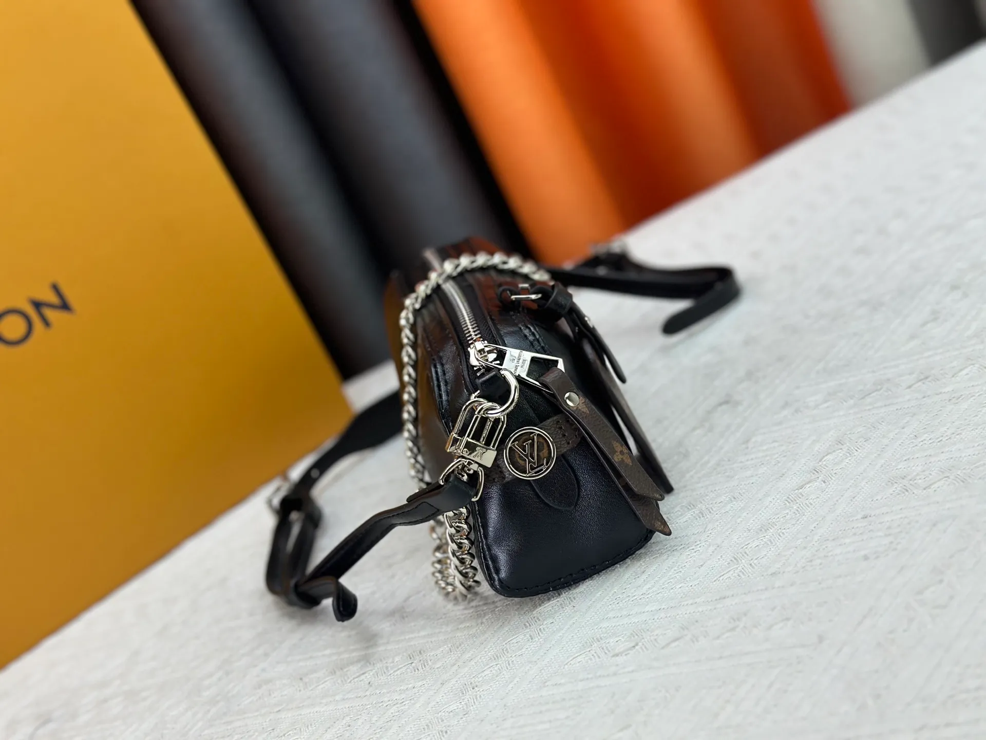 P240 M14544 This Pochette Vibe handbag comes from the LV Vibe series. It has a shiny soft sheepskin body and an eye-catching chain strap. Monogram address plate and LV Circle logo highlight the brand's style. The reversible shoulder strap renews the original design of the Carryall LV Vibe handbag, providing a variety of carrying options. 10 x 7.5 x 25 cm (height x width x length)