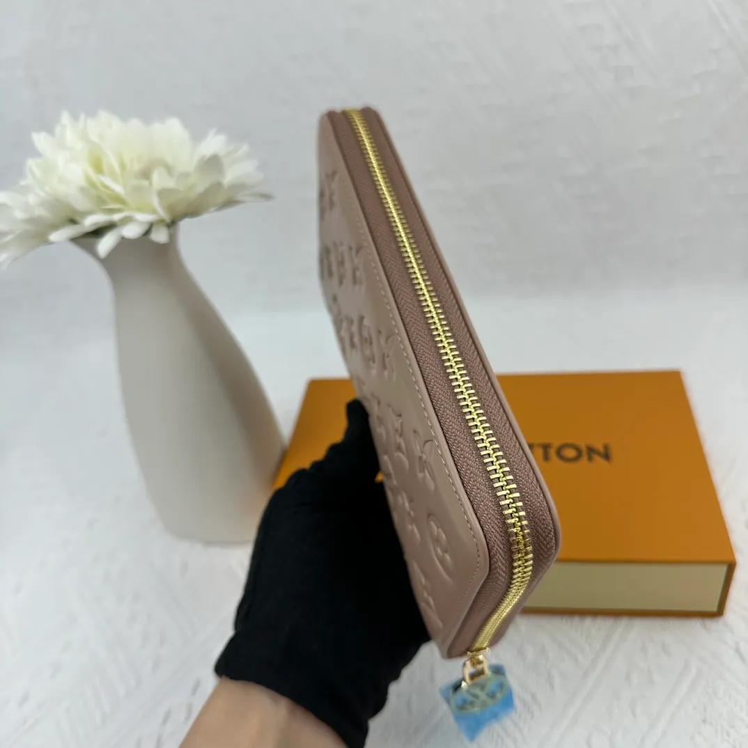 P130 M81511 Apricot Sewn with padded Monogram embossed lambskin, it complements the Coussin leather boutique series. Beautifully designed with a gold-tone zipper embossed with the LV Circle signature pull, the interior of the all-in-one wallet is packed with practical features, including three large compartments, a coin compartment and 12 business card slots. Dimensions: 19.5 x 10.5 x 2.5 cm