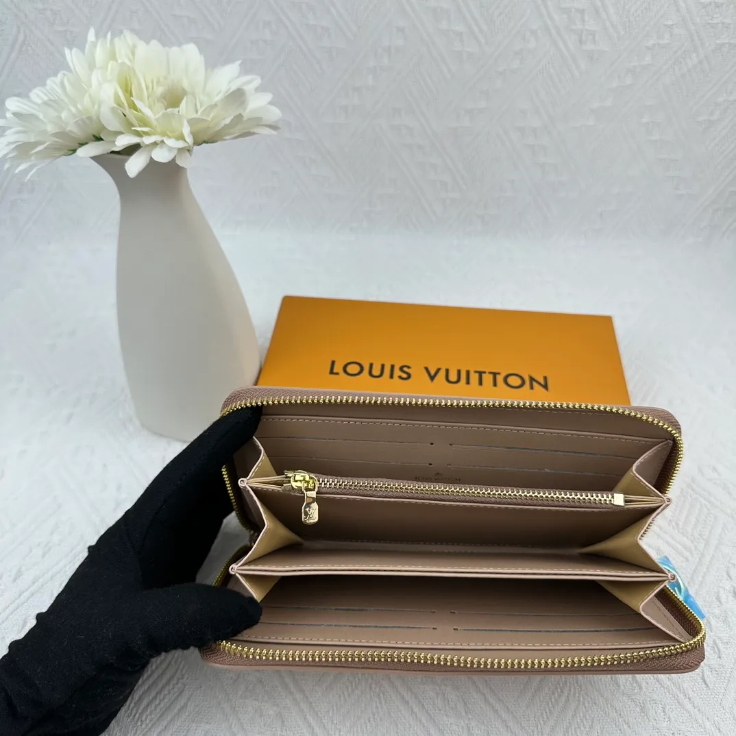 P130 M81511 Apricot Sewn with padded Monogram embossed lambskin, it complements the Coussin leather boutique series. Beautifully designed with a gold-tone zipper embossed with the LV Circle signature pull, the interior of the all-in-one wallet is packed with practical features, including three large compartments, a coin compartment and 12 business card slots. Dimensions: 19.5 x 10.5 x 2.5 cm