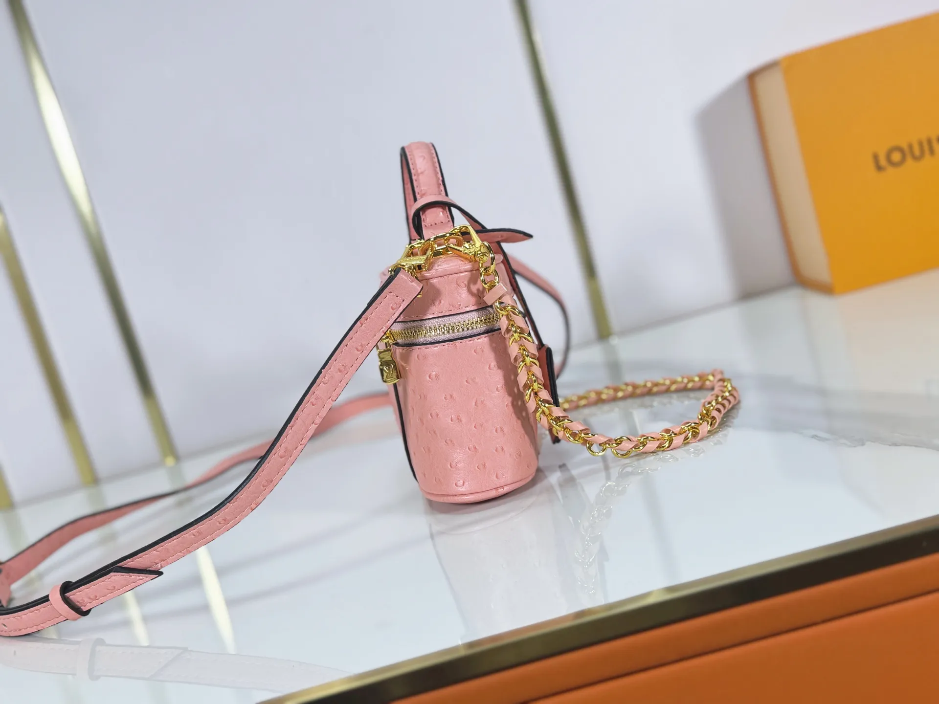 P240 M85911 M85820 M47125 Ostrich leather Vanity Chain Pouch cosmetic box chain bag is inspired by traditional cosmetic boxes and embodies the spirit of travel. This refined, slim bag is trimmed with goatskin trim on the top handle and features a removable braided chain. It is known for its rich collection of iconic details, including LV engraved padlocks and ostrich leather key bells. size：19x11x.5x6.5cm