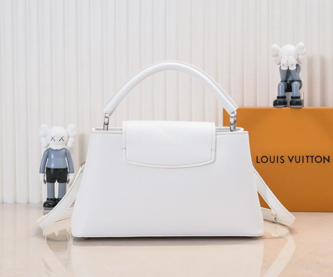 Upgraded version P440 M24664 This medium-sized CapucinesEastWest handbag is from the LVCrush series, with eye-catching forged LV letters lighting up the grained cow leather body. The rolled leather top handle allows for hand or elbow carry, and the adjustable and removable spaghetti strap makes it easy to carry over the shoulder. Personalized Gift Detailed Features 33 x 19 x 9 cm (Length x Height x Width)