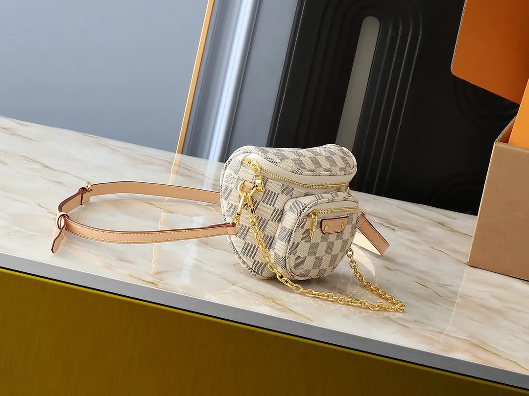 💰220💰Upgraded from the original M46917 M82335 M83275 M82208 M82347 This Mini Bumbag handbag comes from the LV Gradient series and uses the Monogram embossing of Monogram Empreinte leather to render gradient midsummer colors. The on-trend construction features a zipped main compartment and a front pocket with a Louis Vuitton leather label. With the detachable chain and detachable and adjustable shoulder strap, it can be worn as a shoulder or cross-body bag. 17.0 x 12.0 x 9.5 cm (L x H x W) • Monogram Empreinte embossed soft-grained cowhide leather • Textile lining • Metal hardware • Zip closure • Zip front pocket • Shoulder strap: removable, adjustable • Half-length strap: 32.0 cm • Half-length strap adjustable to: 44.0 cm • Chain: Removable • Half-length chain: 20.0 cm