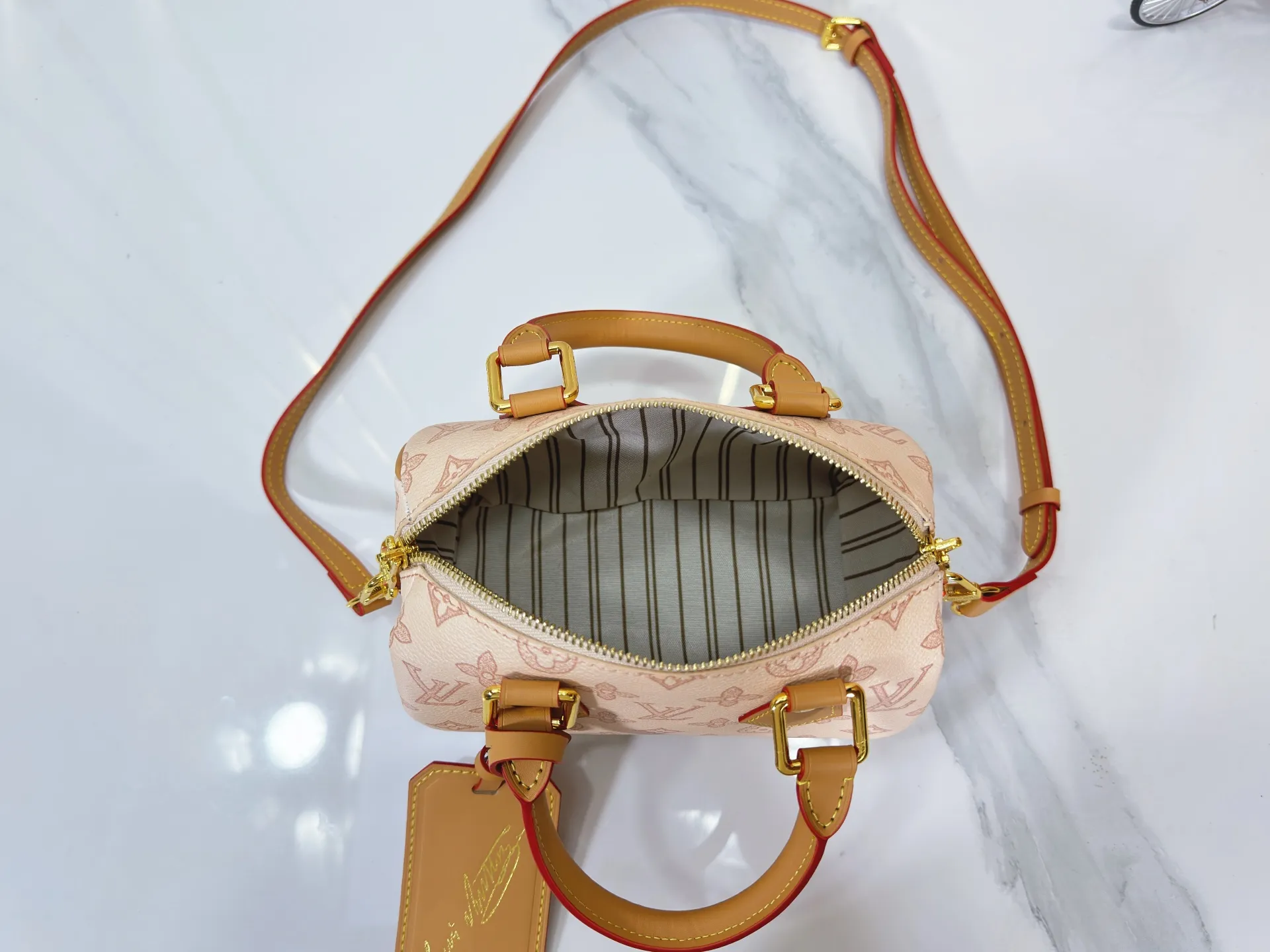 P240 M27951 M27530 Upgraded original version [Exclusive background shot] This Speedy Bandoulière 20 handbag condenses the brand's traditional Speedy travel bag design and is made of Monogram leather with fabric lining and cow leather trim. The wide, removable and adjustable fabric shoulder strap features Louis Vuitton's signature texture, and the rolled leather handles add to the carrying options. 20.5 x 13.5 x 12.0 cm (L x H x W) • Monogram coated canvas • Cow leather trim • Textile lining • Metal hardware • Padlock • Internal slip pocket • Shoulder strap: removable, adjustable • Strap half length: 39.0 cm • Strap half length adjustable to: 58.0 cm • Handle: Double handle