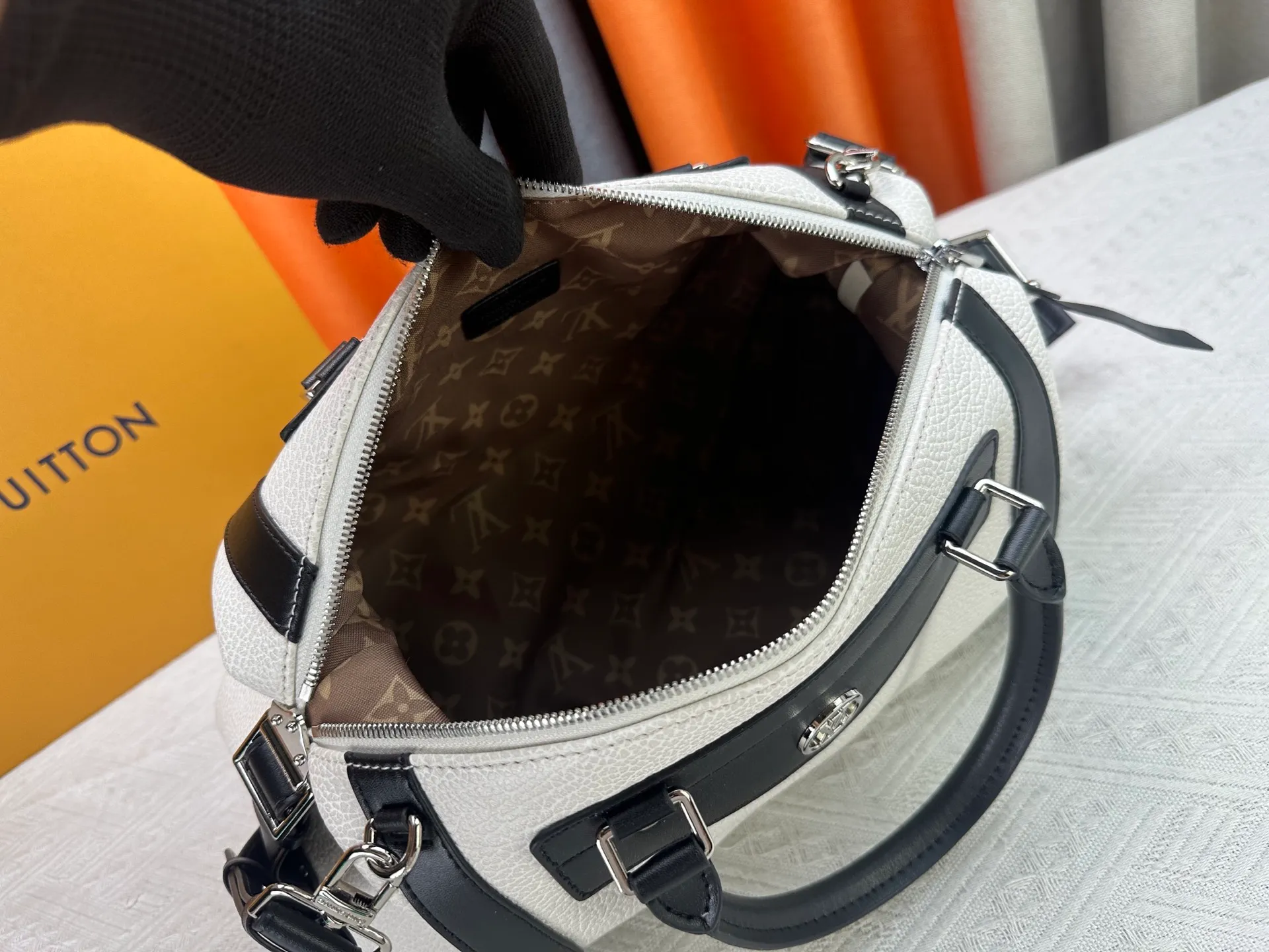 P300 small P320 medium P340 large M25557 M25561 M25561 M25566 Black M14623 mini M14514 small M14700 medium Dark gray M14702 medium Light gray M14721 small This Nano LV Rider handbag is from 2025 For the spring and summer series, pixelated grained sheep leather is blended with smooth cow leather elements, and the LV Circle logo is highlighted with elegant patches. The foldable configuration makes it easy to store in a suitcase, and the modern design adds a rock-n-roll edge to any look.  Mini 10 x 10 x 23 cm Small 12 × 12 × 30 cm Medium 15 × 15 × 38 cm (H x W x L) Sheep leather Cow leather trim Textile lining Metal hardware Zipper closure Side slip straps Internal pocket Holds a 6.7-inch smartphone, Romy card holder and lipstick Shoulder strap: removable, adjustable Strap half-length: 30.0 cm Bag strap half length adjustable to: 45.0 cm Handle: double handle