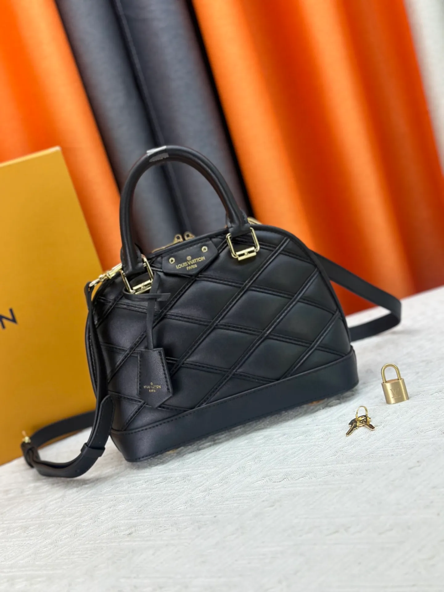 P360 M83048 M53152 This Nano Alma handbag is a pocket-sized version of Louis Vuitton's classic Alma handbag. It is made of soft lambskin with a Malletage quilting pattern, recalling the diamond inner panel of the brand's traditional hard luggage. The elegant handle, dazzling chain and detachable and adjustable leather shoulder strap enable a variety of carrying styles. Dimensions: 23.5x17.5x11.5cm