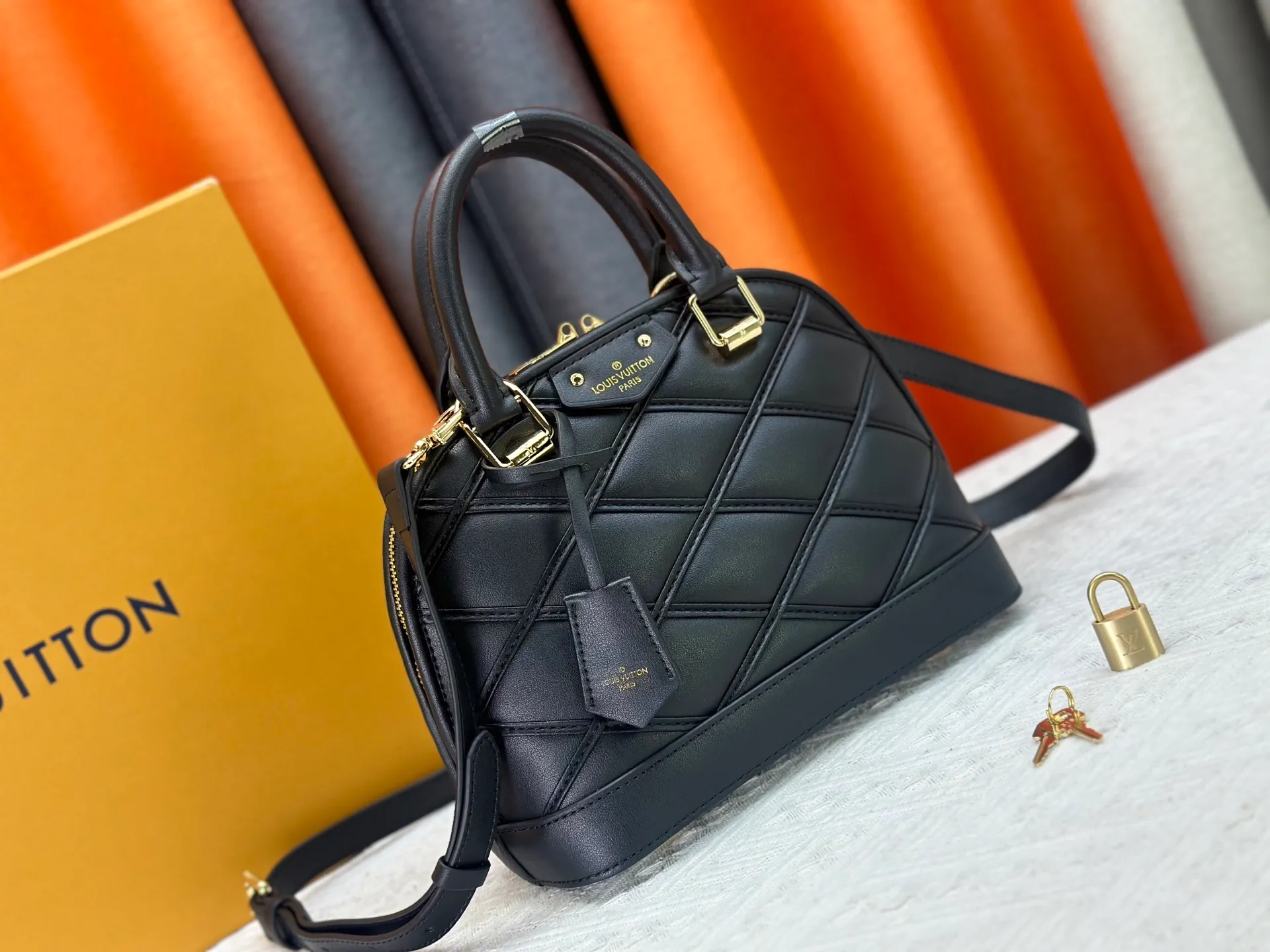 P360 M83048 M53152 This Nano Alma handbag is a pocket-sized version of Louis Vuitton's classic Alma handbag. It is made of soft lambskin with a Malletage quilting pattern, recalling the diamond inner panel of the brand's traditional hard luggage. The elegant handle, dazzling chain and detachable and adjustable leather shoulder strap enable a variety of carrying styles. Dimensions: 23.5x17.5x11.5cm