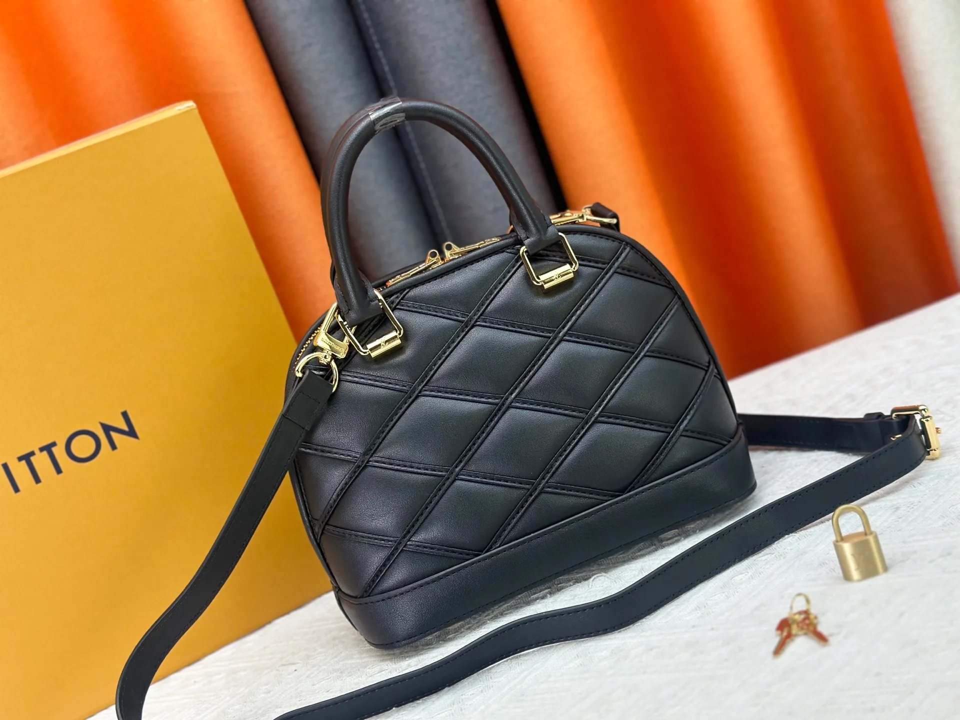P360 M83048 M53152 This Nano Alma handbag is a pocket-sized version of Louis Vuitton's classic Alma handbag. It is made of soft lambskin with a Malletage quilting pattern, recalling the diamond inner panel of the brand's traditional hard luggage. The elegant handle, dazzling chain and detachable and adjustable leather shoulder strap enable a variety of carrying styles. Dimensions: 23.5x17.5x11.5cm