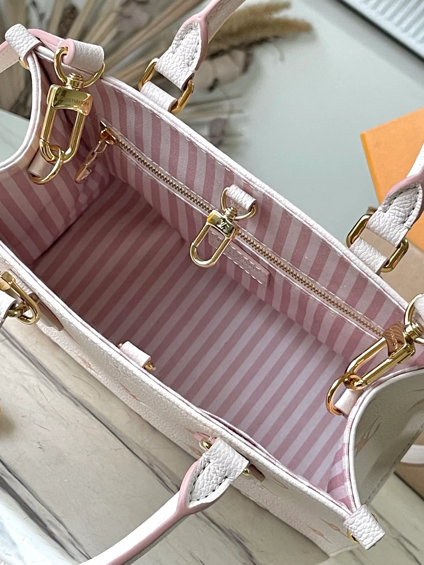 💰1060 (top-grain leather) top-quality original M14403 This OnTheGo small handbag renews the brand's classic Monogram Empreinte leather, using the same tone to outline the pattern. The detachable metal chain accentuates the details, the striped fabric lining adds an elegant touch, and the detachable shoulder strap allows for shoulder or cross-body wear. Dimensions: 25 × 19 × 11.5 cm