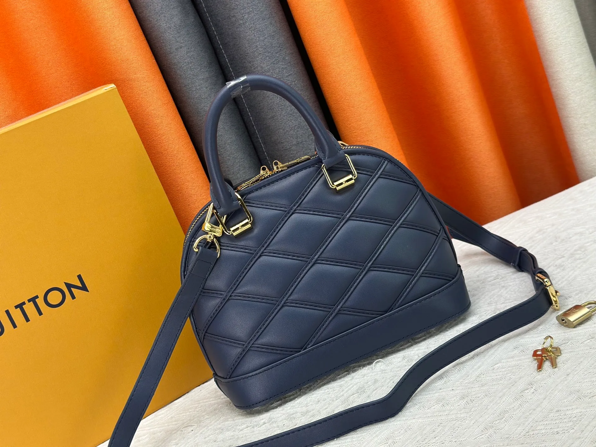 P360 M83048 M53152 This Nano Alma handbag is a pocket-sized version of Louis Vuitton's classic Alma handbag. It is made of soft lambskin with a Malletage quilting pattern, recalling the diamond inner panel of the brand's traditional hard luggage. The elegant handle, dazzling chain and detachable and adjustable leather shoulder strap enable a variety of carrying styles. Dimensions: 23.5x17.5x11.5cm